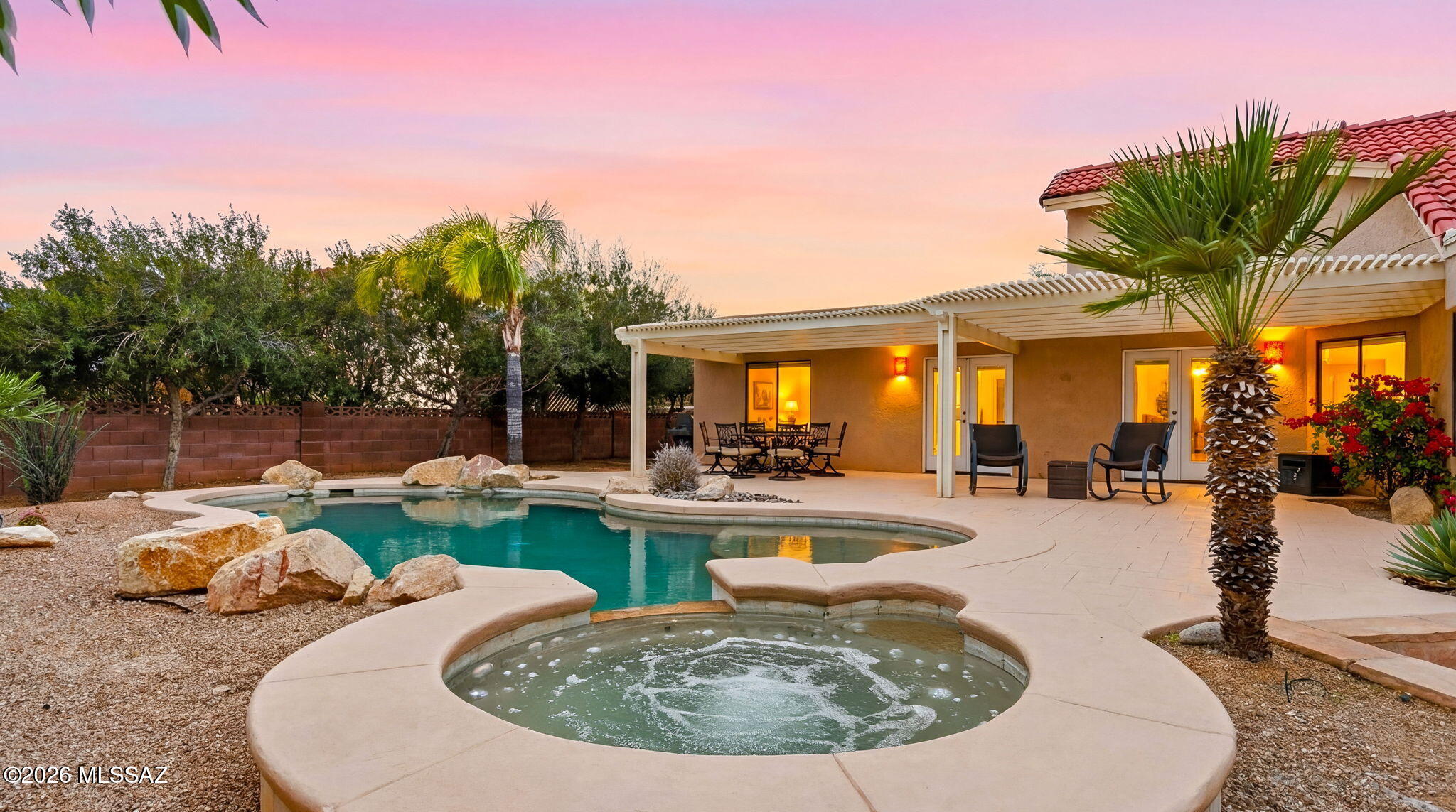 Amazing Desert Sanctuary on .7 acre  only 1 mile from Mt Lemon Biway in the shadow of Majestic Catalina Mtns. Versatile Split Floor Plan  has 2 wings so terrific Multi-Gen home with plenty of space for everyone. In sought after Tanque Verde School District, this property enchants with a completely private rear yard oasis +  extended natural area w/Fire Pit, TUFF Shed & Mesquite Trees. The  FULL LENGTH shady patio w/classic Flagstone Pavers helps keep the home cool.  Remodeled Kitchen delivers beauty w/Stunning Granite Counters/Travertine Backsplash/Cherry Wood Cabinets, Island AND Peninsula open to Great Room; an entertainer's delight:) All 3 Bathrooms Updated. 4 sets of Charming Graphite French Doors lead to extensive retreat patio. Elegant Travertine Flooring. New Water Heater. See more Entire home replumbed! West Wing built in 2005. NEW Irrigation System front/rear to include Low Voltage Wiring. Varying ceiling heights, arches and angles add intrigue to the layout that has ease of flow. Then, one step outside to the backyard retreat and you are a world away to relax & enjoy the awe inspiring Pebble Tec lagoon entry Pool & large Spa with waterfall & decorative boulders. Or, grab binoculars to enjoy countless varieties of birds that inhabitat.  Whether you enjoy sunrise, sunset, mountain VIEWS or big skyscapes that Tucson is famous for, all is yours to soak in without leaving home!!