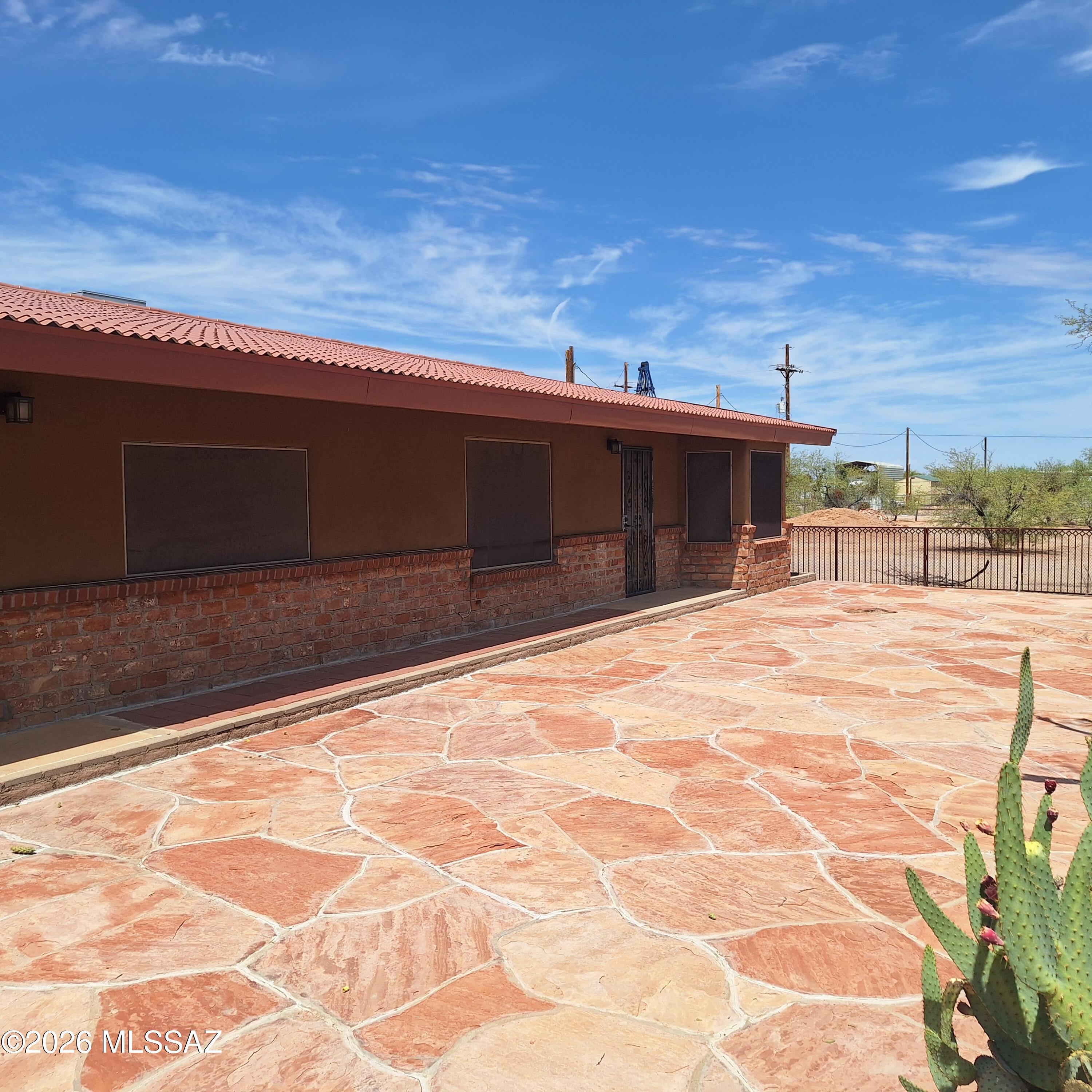 Beautiful with numerous upgrades:1800sf 2Br, 2Ba home on fully fenced 4.77 acres, Marana School District, wide-open living on private acres. Home boasts numerous upgrades, large open kitchen, upgraded cabinets, rounded marble brkfst bar off liv room, large laundry room, AC, tankless water heater, metal roof tile look, nice covered deck with gas hook-up, flagstone patio, walled in courtyard.  Plenty of horse facilities; covered stalls, mare motel with tack room, additional stalls, 150' X 300' steel pipe fenced arena with 2 holding pens, 4-horse walker (Centuar), Spacious master suite features a walk-in closet, Jacuzzi tub. Horse corrals, barn, turnout, 2- RV hookups, and trailer parking add equestrian appeal. Unwind beneath covered patio while enjoying breathtaking Arizona sunsets.