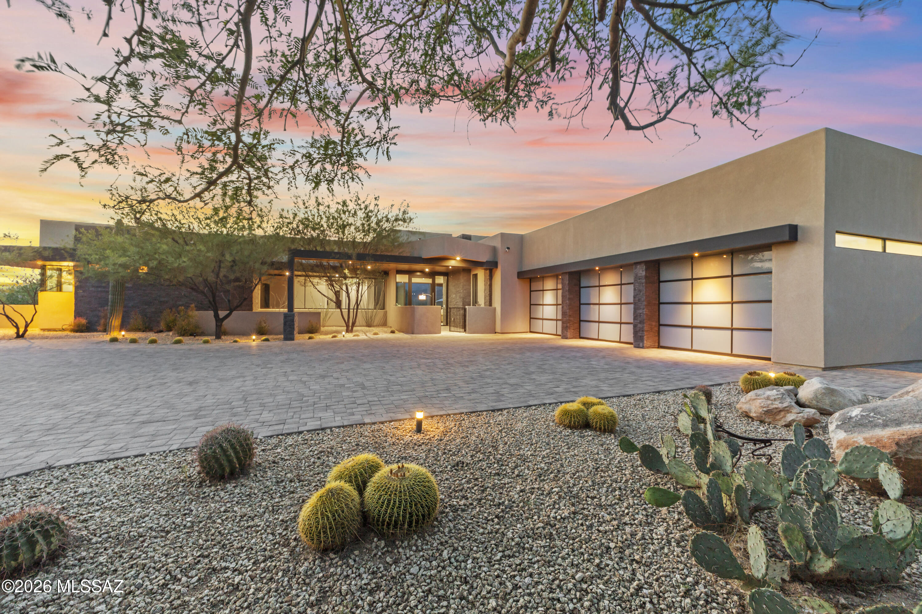 Set on a private .76-acre lot in Oro Valley's prestigious Stone Canyon community, this architectural masterpiece by renowned designer Marc Soloway blends clean contemporary lines with the raw beauty of the Sonoran Desert. Built in 2018 & spanning 3,682sf, the home is thoughtfully positioned to capture unobstructed Tortolita Mountain views protected by over 25 acres of HOA-owned open space directly behind the property. Experience striking modern design and effortless desert living with an open-concept floor plan that is both sophisticated & functional with 3BRs/4½BAs + versatile den/office/workout space w/patio access. Each bedroom is a private retreat with an ensuite bath & walk-in closet. Great room is designed for connection & comfort, anchored by high ceilings, gas fireplace with mantle, expansive collapsing sliding glass doors for seamless indoor-outdoor living w/remote-controlled window shades. Sleek chef's kitchen features quartz counters, stainless appliances, large island w/bar seating & walk-in pantry. Bar area has sink, wine cooler & ice maker making it ideal for entertaining or everyday living. Sophisticated powder room w/contemporary floating vanity, quartz counters, integrated vessel sink & elegant pendant lighting. Enjoy your own private backyard retreat, thoughtfully designed with low-maintenance desert landscaping, an extended paver patio, and wrought iron fencing with added snake-proofing. Take in breathtaking sunrises and sunsets as they paint the mountains in ever-changing color. The outdoor space is perfect for relaxing or entertaining, featuring a built-in BBQ, patio solar shade, and a soothing Vita 92x92 Envie spa ideal for unwinding under the desert sky. Residents enjoy membership at the exclusive Stone Canyon Club with access to the championship golf course, luxurious fitness facilities, tennis, pickleball and restaurant. This is a rare opportunity to own a modern desert sanctuary where architecture, privacy, and views come together in perfect harmony. Adjacent to the community are protected areas such as the Vistoso Trails Nature Preserve  and Honey Bee Canyon Park,& Catalina State Park which offer hiking trails and natural desert habitat.