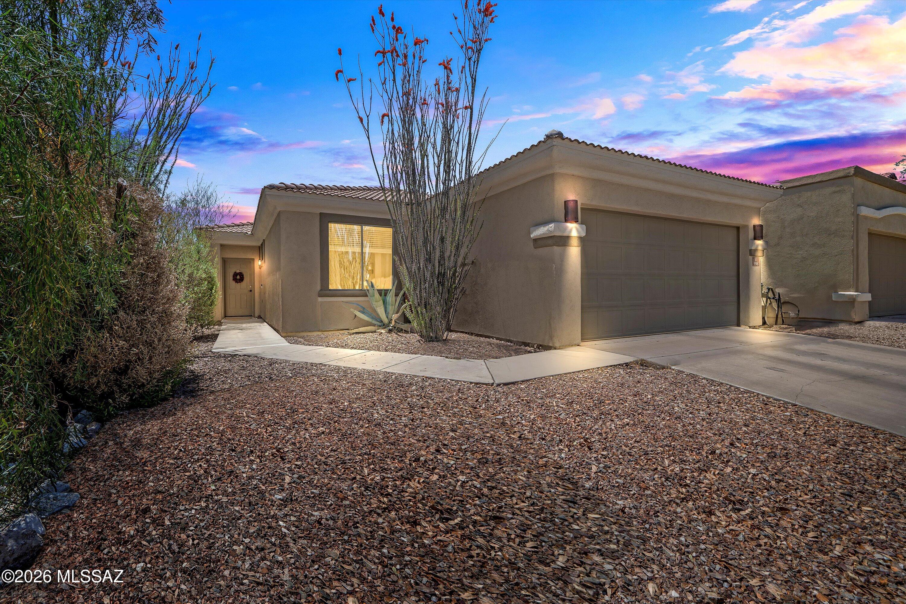 Tucked away on a peaceful private street in the award-winning community of Rancho Sahuarita, this charming single-story home offers a warm welcome from the moment you arrive. With its own green space and park area directly in front, it provides an extra layer of serenity and charm, perfect for peaceful morning strolls or playful afternoons. Step inside to discover an inviting, light-filled interior featuring beautiful neutral-tone tile plank flooring that runs seamlessly throughout. The thoughtfully designed layout offers an airy, open-concept feel, complemented by a spacious laundry room that adds ease to everyday living. The kitchen is a delight with crisp white cabinets, stainless steel appliances, and a clean, contemporary aesthetic that flows effortlessly into the living and dining areas. The primary suite feels like a personal retreat, showcasing a walk-in closet and a spa-inspired ensuite bath complete with a soaking tub and upgraded tiled shower.
Out back, the fully landscaped yard is both functional and charming, featuring raised flower beds, artificial grass, a covered patio, and stepping stones that invite you to enjoy Arizona's beautiful outdoor living.
This home has been lovingly maintained and is in amazing condition. With close proximity to the community lake, clubhouse, parks, pools, and all of Rancho Sahuarita's celebrated amenities, your next adventure starts right here.