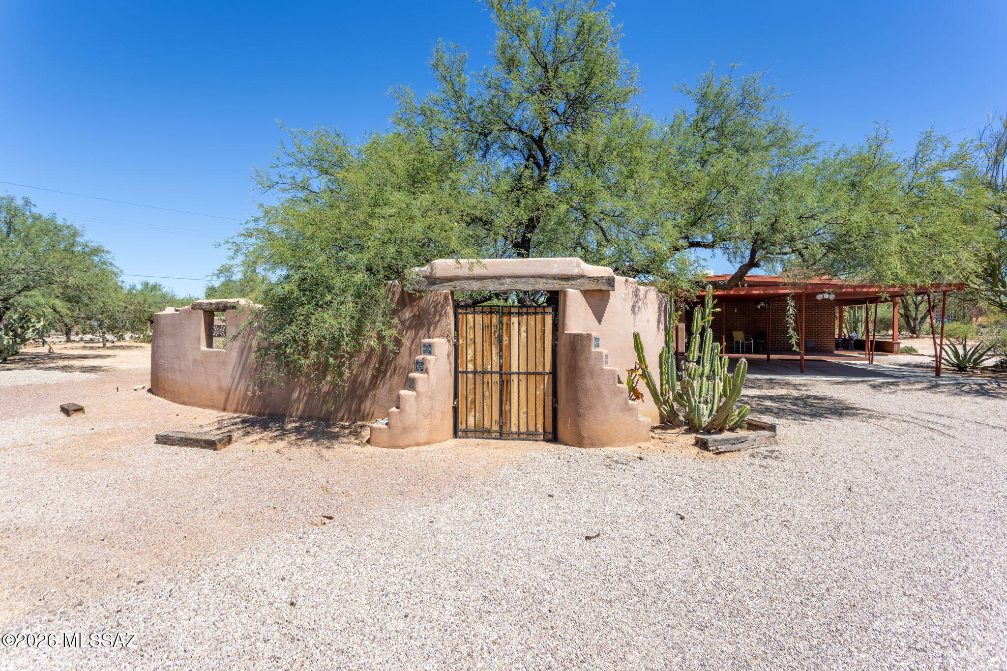 Spectacular views AND the gift of a ONE YEAR HOME OWNERS WARRANTY are just a few of the perks in this charming Northwest Tucson home. Amazing view of Pusch Ridge from the front entry & large window in the living room. In the evening enjoy the beautiful sunsets from your own private backyard oasis. This 1,400 SF home features two bedrooms; a primary bedroom with an ensuite room to use as den or office, and a large guest bedroom.  The ensuite space can be easily converted to a 3rd bedroom. Two fully remodeled bathrooms, one with a granite countertop & the other a beautiful tile countertop. The fully remodeled kitchen has granite countertops and new solid wood cabinetry with loads of storage.  This .84 acre lot has plenty of room for growth to make this property your own.