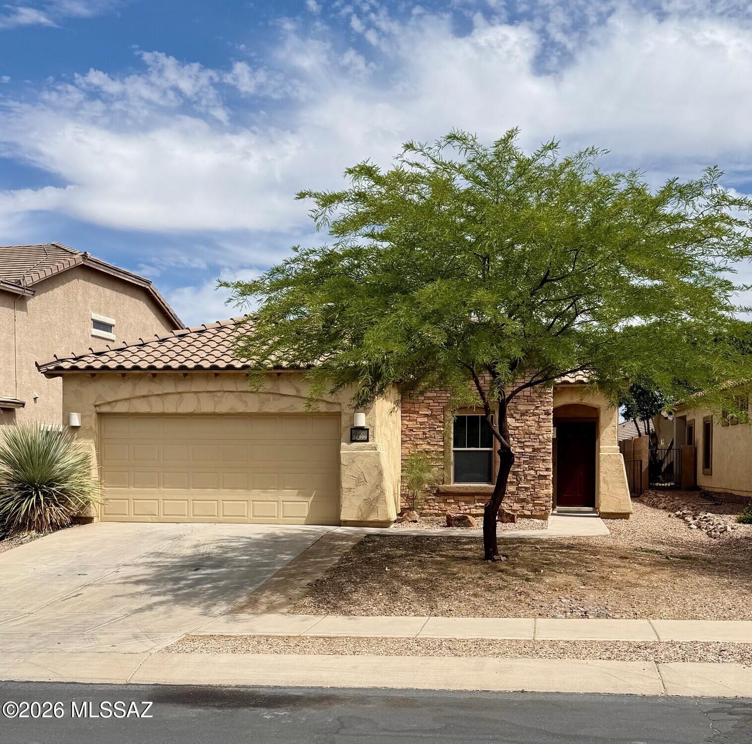 Wonderful Pulte built 4BD/2BA single story home in the beautiful Rancho Sahuarita community featuring: a gorgeous kitchen with lots of counter space, kitchen island, and stainless appliances, large open great room with lots of natural light, new vinyl plank flooring,  raised ceilings, upgraded tile in kitchen, baths and entry way, ceiling fans throughout, fresh interior custom paint., upgraded light fixtures, new carpet in guest bedrooms, wood flooring in master bedroom designer California Closets(can be converted back to original), master bath with tile shower base. Enjoy the peaceful walled in backyard from the covered patio with citrus trees and pavers. NEW Roof 2024, New HVAC Heat Pump 2026.  Rancho Sahuarita amenities- swimming, fitness, lake activities. Owner is licensed Agent in AZ