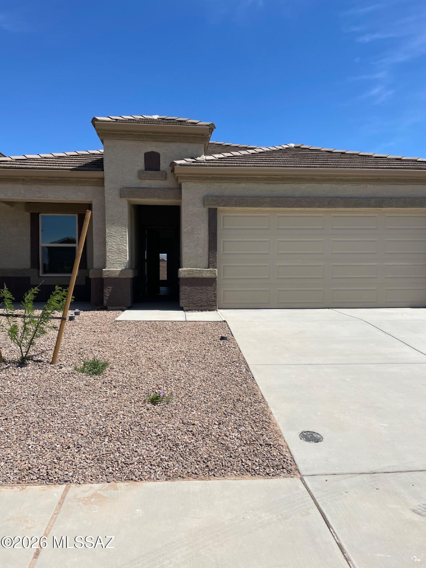 1,787 SQ FT! 4 bedroom, 2 bath home in Marana's desirable Saguaro Bloom community! 2022 build with modern features throughout. Welcoming single story floor plan! Stunning eat-in kitchen with expansive center island/breakfast bar. **Fridge To Be Installed Upon Request!** Open living/dining, great for entertaining! Neutral interior with tile flooring in all the right places. Primary suite offers a full bath + walk-in closet! Nicely sized secondary bedrooms. **Blinds To Be Installed!** Low up keep backyard with covered patio &amp; stunning mountain views. 2 car garage! Saguaro Bloom is a well maintained community with community pool, sports courts, playgrounds, &amp; biking/walking trails throughout.