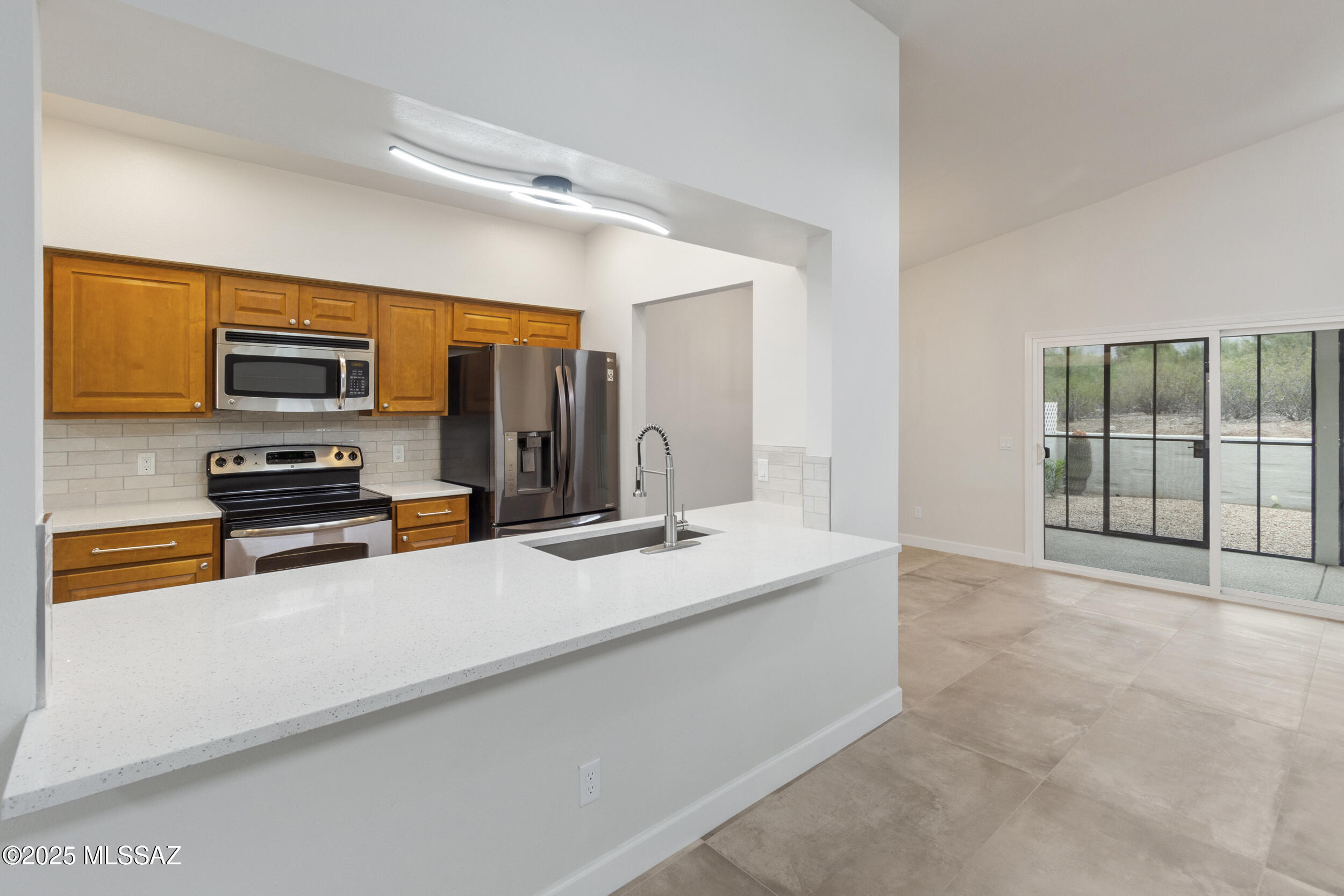 Experience a premium, high-efficiency renovation in Quail Canyon with unobstructed mountain views. This North/South facing gem offers unmatched peace of mind with new energy-efficient windows and sliding glass doors, a freshly sealed roof, and a new water heater (all 2025). The interior features modern large-format tile, quartz countertops, a breakfast bar, and two entirely new luxury bathrooms. Enjoy indoor-outdoor living with an enclosed AZ room, a private front courtyard, and a low-maintenance rear yard bordering open space with no neighbors behind. Located 3 minutes from Sabino Canyon recreation, golf, and dining. Priced for immediate interest. Community pool and spa are heated all winter. Owner/Agent.