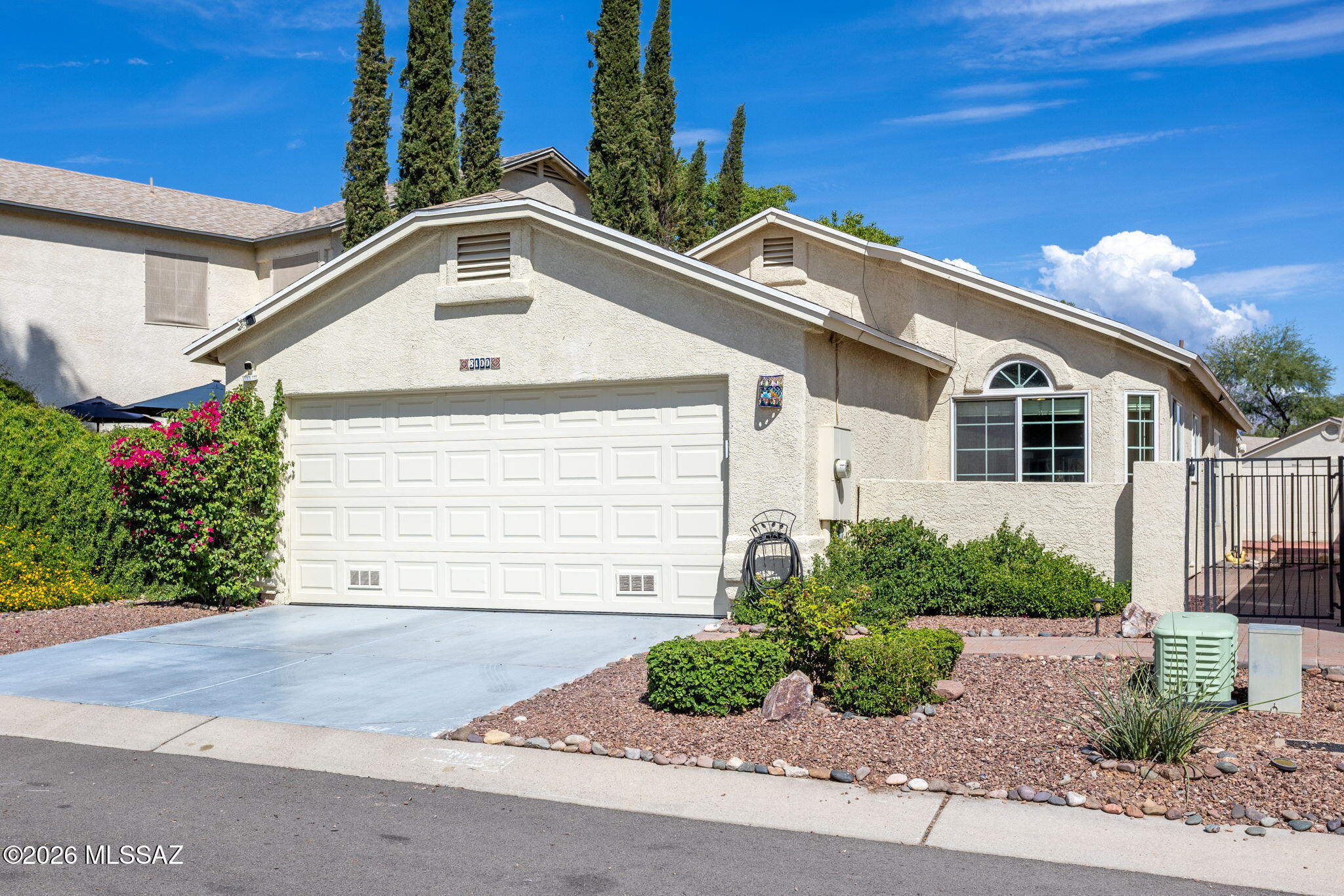 Charming, easy-care living in a welcoming community! This delightful 3-bedroom, 2-bath home offers inviting curb appeal, desirable floorplan, and a low-maintenance lifestyle. A gated front courtyard creates a warm and private entry, while the interior features an open concept with a split-bedroom floor plan placing the primary suite thoughtfully separated from the guest bedrooms--ideal for everyday living or hosting visitors.

The kitchen opens to both a cozy breakfast nook and flows seamlessly into the great room on the other side, where the dining area provides a comfortable space for gathering and entertaining. An enclosed Arizona room extends the living space and offers even more flexibility for relaxing, dining, or enjoying the beauty of the outdoors year-round.

Step outside to a beautifully designed, low-care paver backyard featuring vibrant bougainvilleas for colorful Arizona charm and a mature citrus tree that adds both character and shade. The community offers additional ammenities for recreation with a pool, park, and basketball court conveniently located just down the street.

For added peace of mind, the roof and HVAC have been recently maintained. With its charming curb appeal, easy-care outdoor spaces, functional floor plan, and inviting community amenities, this home is a wonderful opportunity to enjoy comfortable Arizona living with less maintenance.