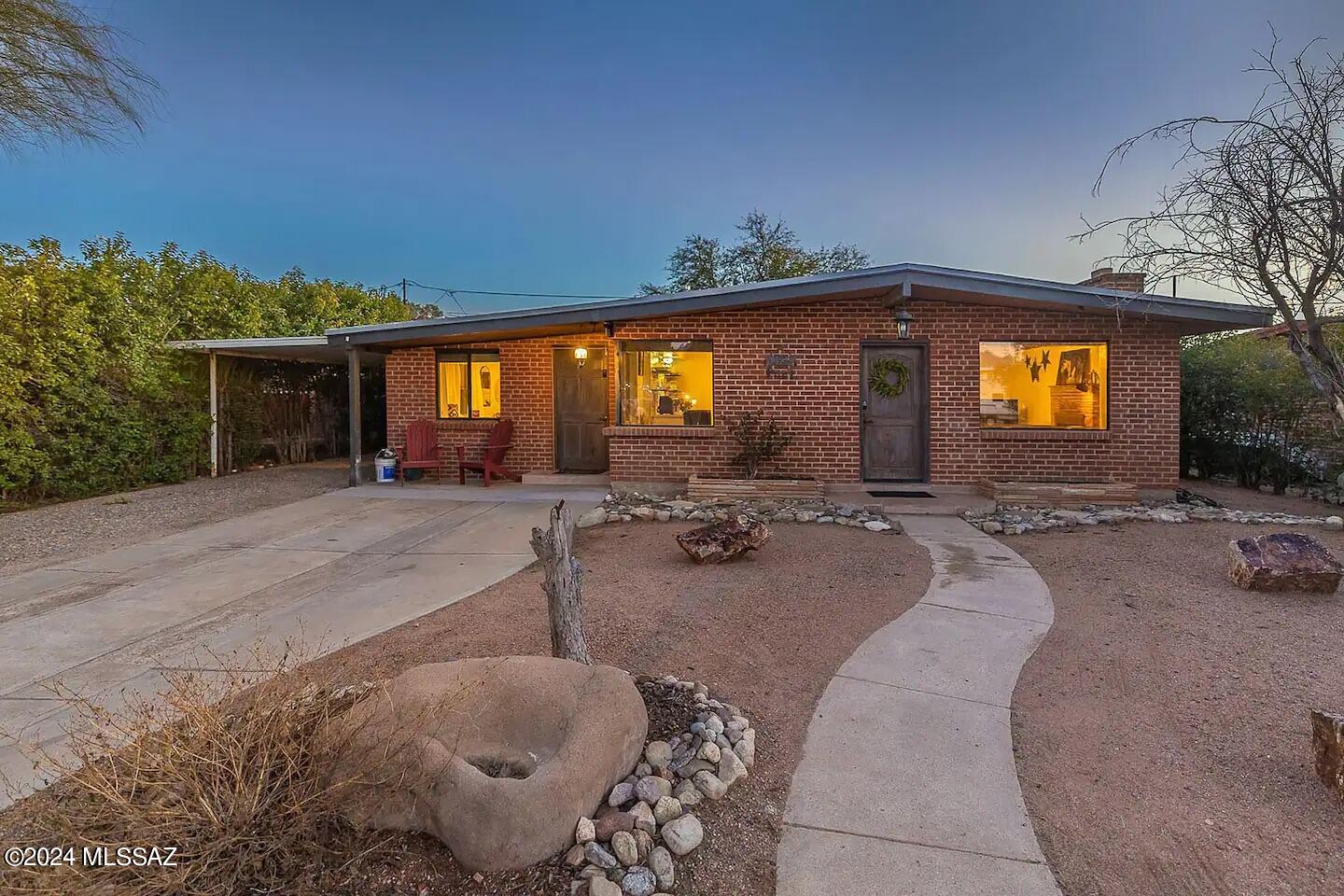 Enjoy all that this updated 4 bedroom, with 3 full bathrooms, with split floor plan and 1,716 square foot home has to offer! Step into the open concept living area with exposed beams and gas fireplace. The large kitchen offers plenty of storage and counter space, including kitchen island, gas cooktop, stainless steel appliances, and large farmhouse style sink. There are two primary bedrooms, each have an updated ensuite and access to the backyard. The outdoor spaces are low maintenance and the backyard is fully finished- with a large patio, turf area and a separate fire pit to enjoy the beautiful Tucson evenings.