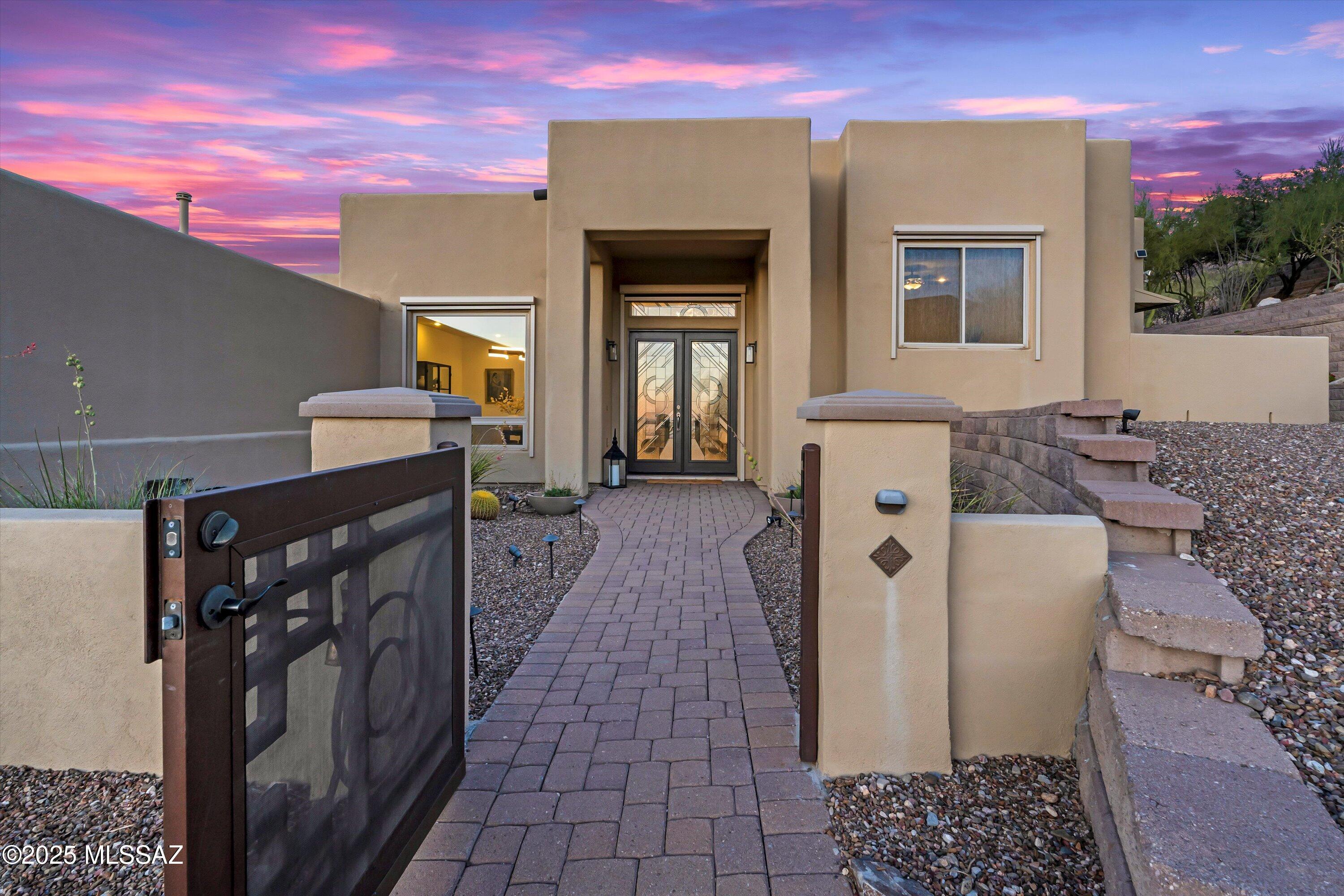 Stunning Home in Gated La Reserve Community - Oro Valley Oasis
 Welcome to your dream retreat in the highly sought-after gated La Reserve community in Oro Valley!  Nestled on a peaceful cul-de-sac, this spacious 3,075 sq. ft. home sits on a generous 0.73-acre lot, offering privacy, tranquility, and breathtaking views of the Sonoran Desert and Pusch Ridge Catalina Mountains. Enjoy glittering Oro Valley city lights and spectacular sunsets from the front courtyard. 

Step inside through a custom glass front door into a bright, airy formal dining room and living room featuring soaring ceilings and floor-to-ceiling windows that frame stunning desert landscape & Catalina Mountains.