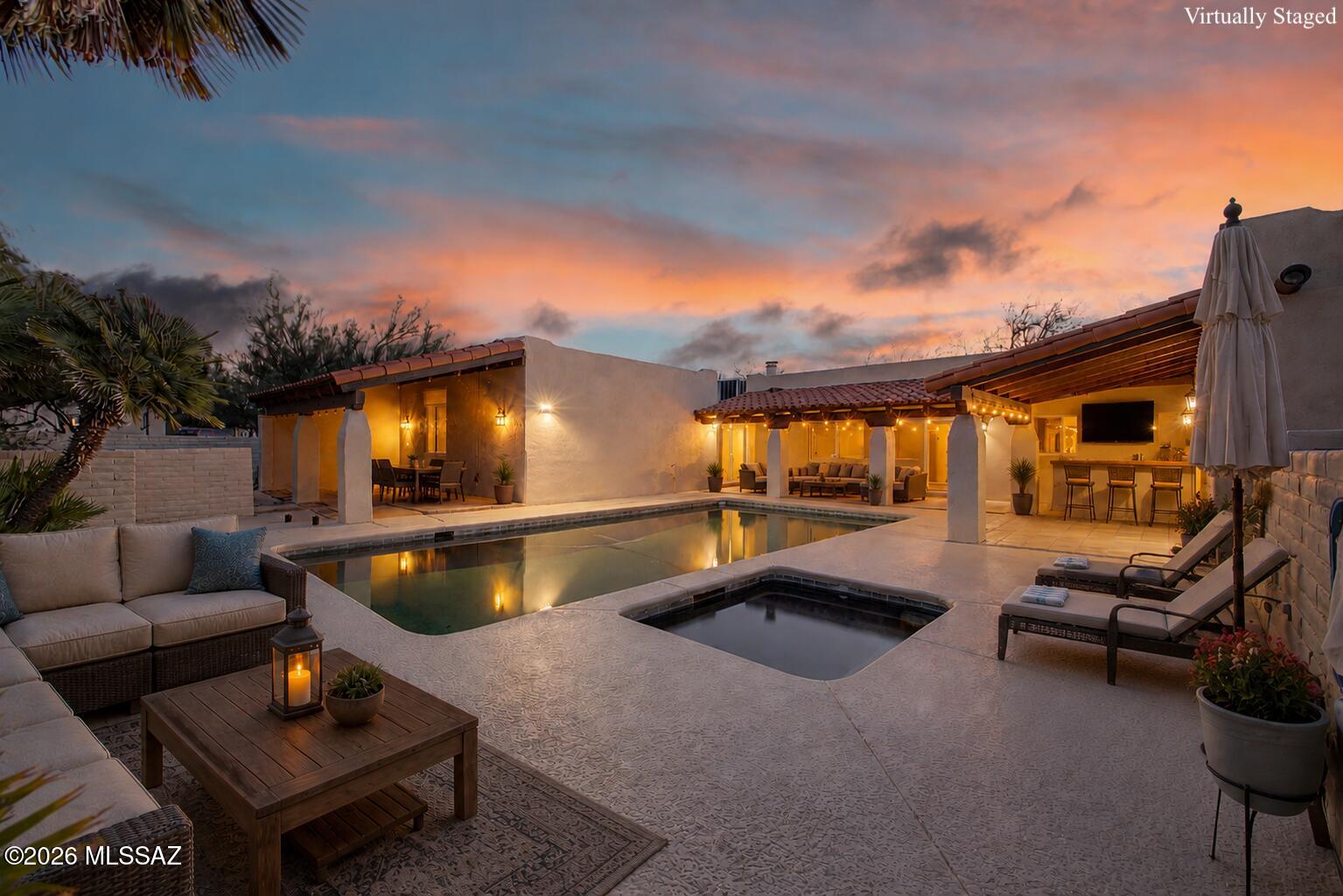 Nestled in a quiet cul-de-sac within the highly coveted Oro Valley Country Club Estates, this enchanting Santa Fe-style home captures breathtaking mountain vistas! Stunning desert landscaping & a charming courtyard welcome you with a lovely fountain & covered patio. Inside, you'll find authentic Saltillo tile flooring, plantation shutters, & skylights that fill the home with natural light. Inviting living and family rooms provide comfortable spaces for entertaining, while a spacious den offers flexibility for a home office or additional living area. The interior presents a wonderful, welcoming canvas ready for your personal vision. The eat-in kitchen features leathered quartz counters, SS appliances, a stone backsplash, & warm wood cabinetry. The main bedroom includes a private bathroom w/dual sinks & a walk-in closet. A separate guest quarter adds incredible value, offering ample living space & its own bathroom--perfect for guests or extended stays. Step outside to an L-shaped covered patio, a solar-heated Pebble Tec pool & spa, and truly impressive desert & mountain views--an ideal setting for relaxing or entertaining.