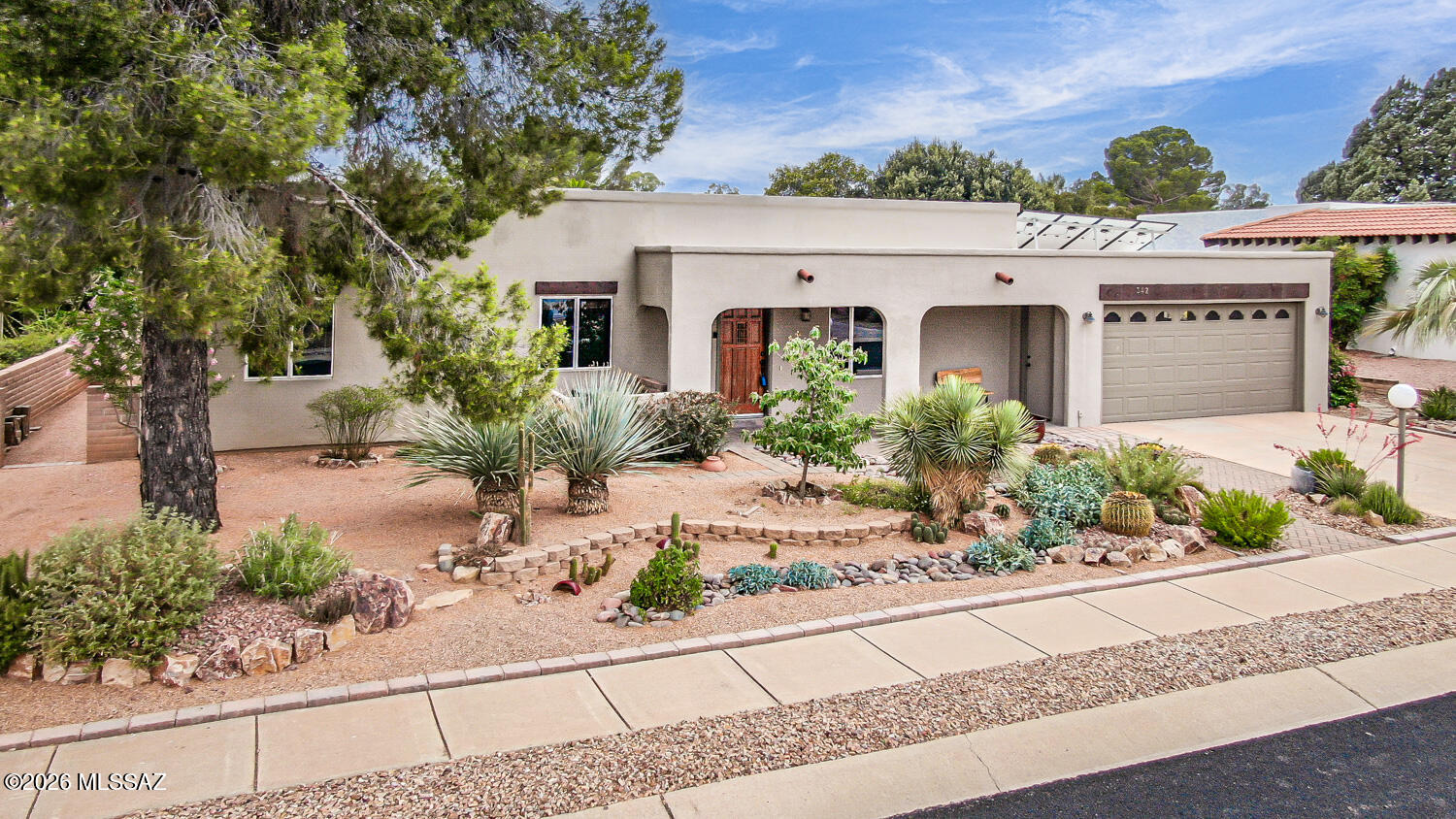 Beautifully maintained 2-bedroom plus den home featuring an incredible gardener's paradise with established fruit trees, raised garden beds, colorful desert landscaping, rainwater harvesting, and automatic irrigation for easy care and sustainability.
The updated kitchen offers quartz countertops, slide-out shelving, and abundant cabinetry. The spacious primary suite includes an ensuite bath and a charming barn door leading to the Arizona Room. A large laundry room with an additional shower and toilet adds extra convenience.
Recent upgrades, including owned solar system that reduces electric bills $1500 annually & new laundry, dishwasher, and water softener appliances, make this home energy-efficient & move-in ready. Enjoy comfortable indoor living and a truly exceptional outdoor retreat