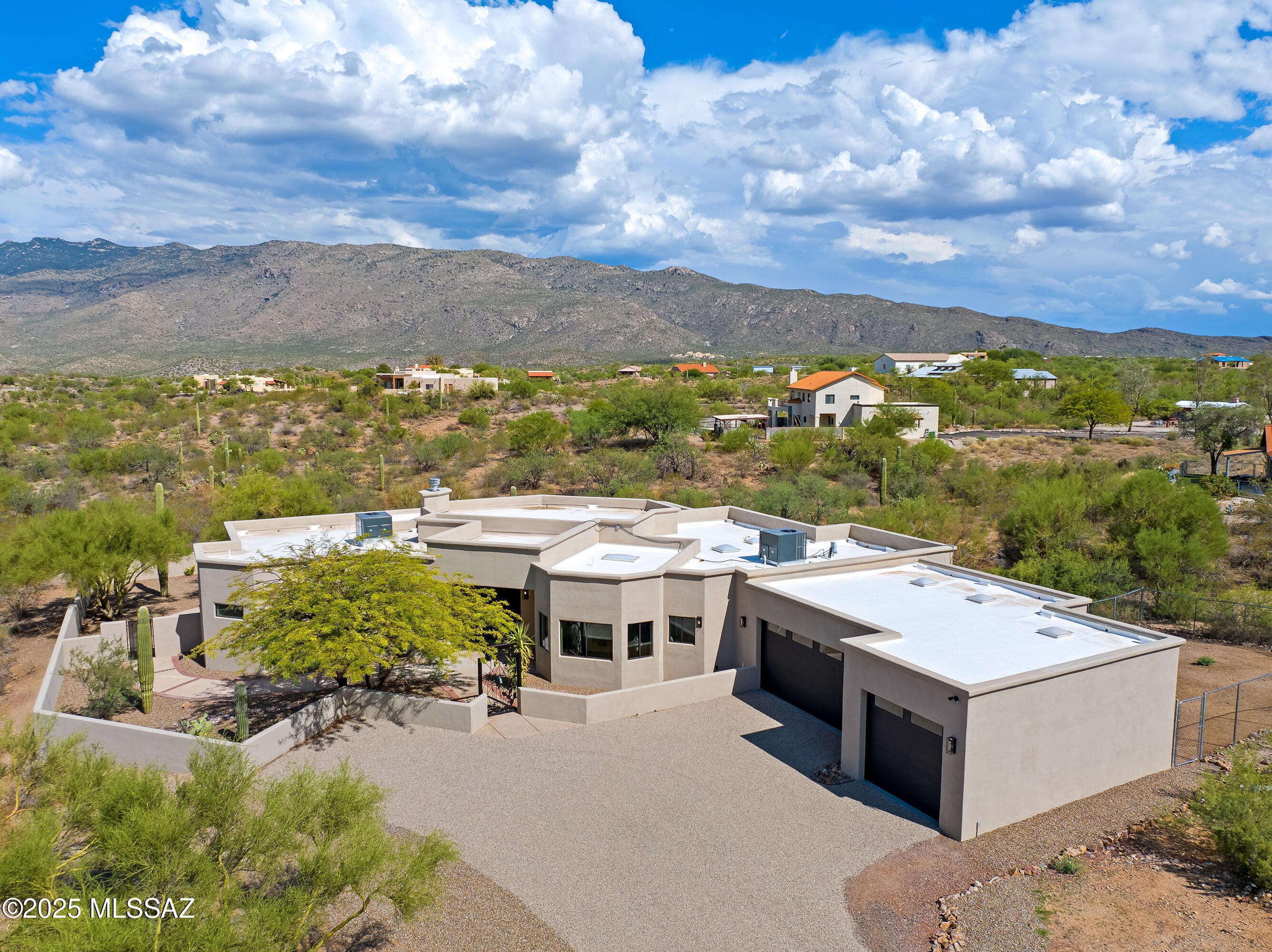 Beautifully remodeled custom Contemporary style home. Located in a scenic East Tucson location. Rich earth tone look ceramic tile floors. Updated modern kitchen with stainless steel appliances. New custom interior and exterior paint. Gas fireplace with pop out accents. Modern bathrooms. En suite bathroom features dual vanities, dual shower heads in shower, and walk in closet. Professionally landscaped front and back yard. Mountain and desert views. Covered porch. Dual pane windows. Three car garage. Bonus fenced side yard. Upgraded door hardware and light fixtures. No HOA. This home shows beautifully.