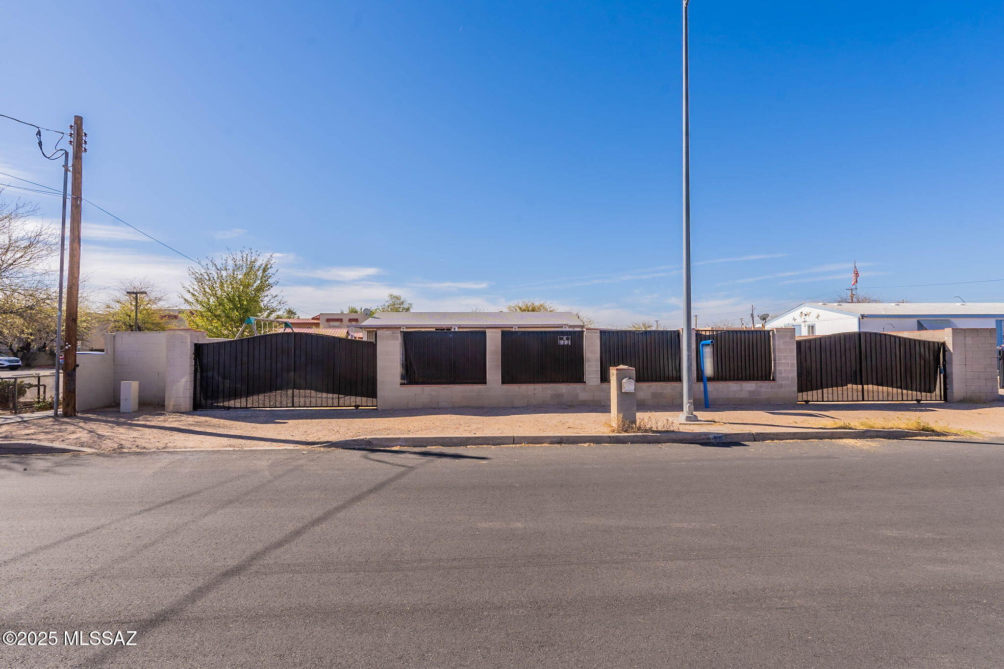 Gorgeous recently remodeled manufactured home on a large desirable lot. Beautiful kitchen with SS appliances, updated bathrooms and wood like vinyl flooring. Fenced front yard with rolling gates, large partially turfed backyard with above ground pool, 2 large storage sheds and a large covered patio. Plenty of parking space for cars and toys! Reduced energy bills with Solar! No HOA. Close to downtown, The University of Arizona, and much more! Could be a great rental/investment property!