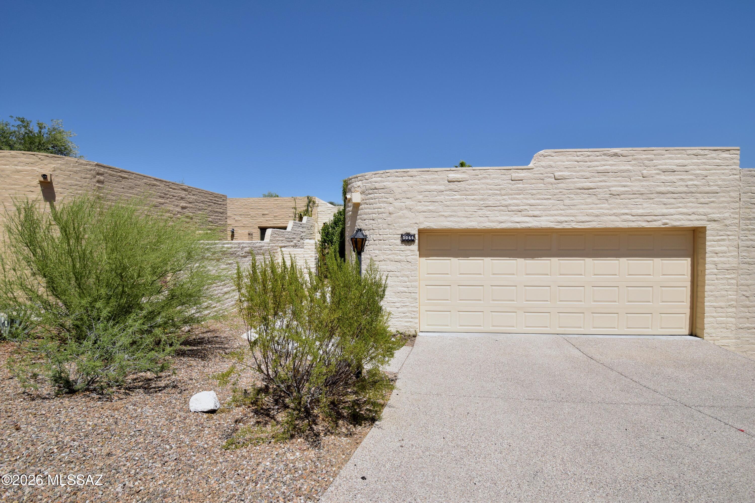 Sunrise at Presidio townhome in the Catalina Foothills. 2 Beds/2 Baths and 1364 SQ FT. Updated kitchen with slab granite counters, newer cabinets, SS appliances, breakfast bar, ceramic top range and french door fridge. Full Size washer/dryer. Open concept with big living/dining/kitchen area. Both baths remodeled with granite, updated vanities and tile shower surrounds. Primary bedroom has private access to patio and 3 door master closet. Quiet backyard with hillside views and lots of mature landscape. Outdoor storage. Extra deep 2 1/2 car garage with epoxy coat. Community has heated pool/spa & tennis courts as well miles worth of beautifully landscaped walking trails. This home is offered as NON-SMOKING. Pets subject to owner approval.
