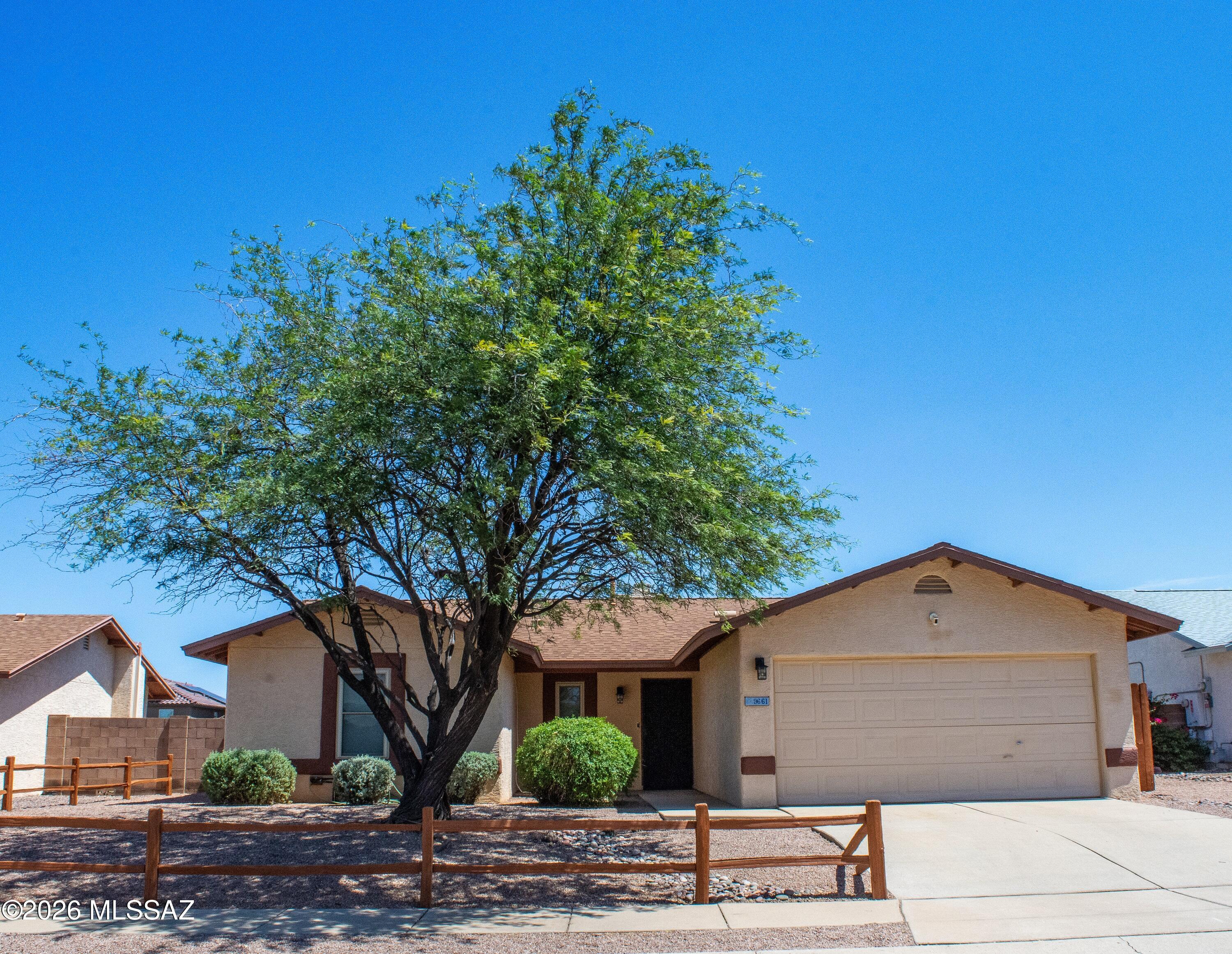 Welcome home to this charming 3-bedroom, 2-bath residence in the desirable Rita Ranch community, located within the sought-after Vail School District. Featuring an open great room floor plan with vaulted ceilings and a cozy fireplace, this home offers comfortable living and plenty of natural light. The spacious Arizona room provides extra space for relaxing or entertaining. Enjoy the covered patio with flagstone, a charming backyard with mature citrus trees, and a separate side yard. A private viewing deck offers the perfect place to see the views. Complete with a 2-car garage, mature shade tree in the front yard, and a walk-in closet in the primary suite, this home is a must-see!