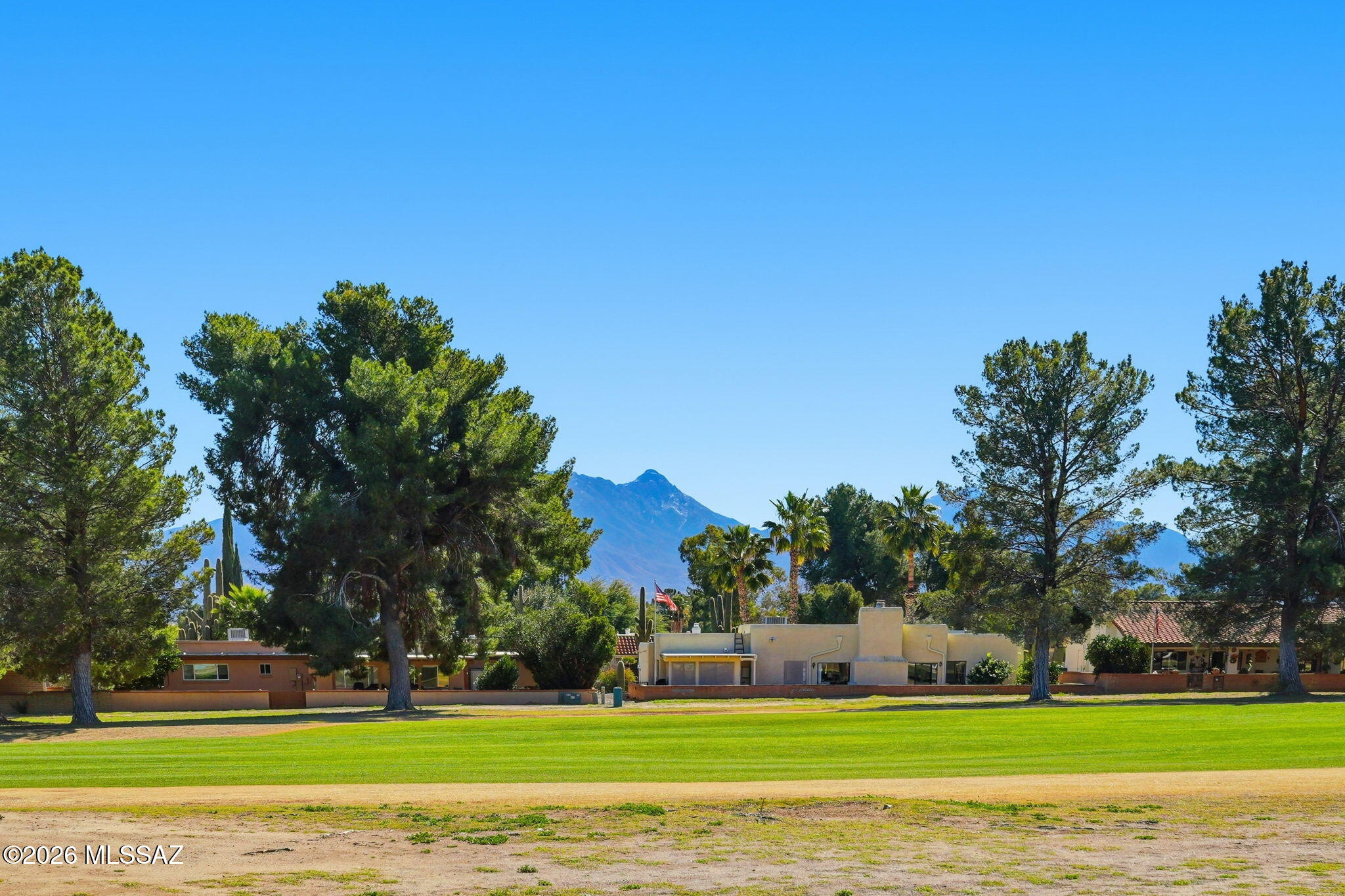Beautifully updated and fully furnished golf course townhome with mountain views, offering two bedrooms and two baths on a premier lot overlooking the Country Club of Green Valley. Embrace the relaxed Southwest desert lifestyle in one of Southern Arizona's most sought-after active adult communities, where sunny days, golf, pickleball, social clubs, and endless recreation create the perfect setting for easy, enjoyable living.

The inviting rear patio provides a peaceful space to unwind, entertain, and take in sweeping mountain and fairway views, while the private front courtyard is ideal for morning coffee or quiet afternoons. Inside, the light-filled great room features a cozy gas fireplace, skylights, attractive ceramic tile flooring, and a dedicated dining area. he spacious kitchen offers white cabinetry, granite countertops, under-cabinet lighting, new stainless-steel refrigerator, range, and microwave (2025), plus a casual eating area with patio access.

Both bedrooms enjoy mountain views, with convenient showers in both bathrooms and charming Mexican tile accents in the guest bath. Additional features include washer and dryer, generous storage, bonus hobby or workspace, and a double carport, providing comfort, functionality, and flexibility.

Recent updates include a new HVAC system and solar (2023), new electrical panel (2023), and perma-lined sewer with a 30-year warranty (2023), offering peace of mind and low-maintenance living.