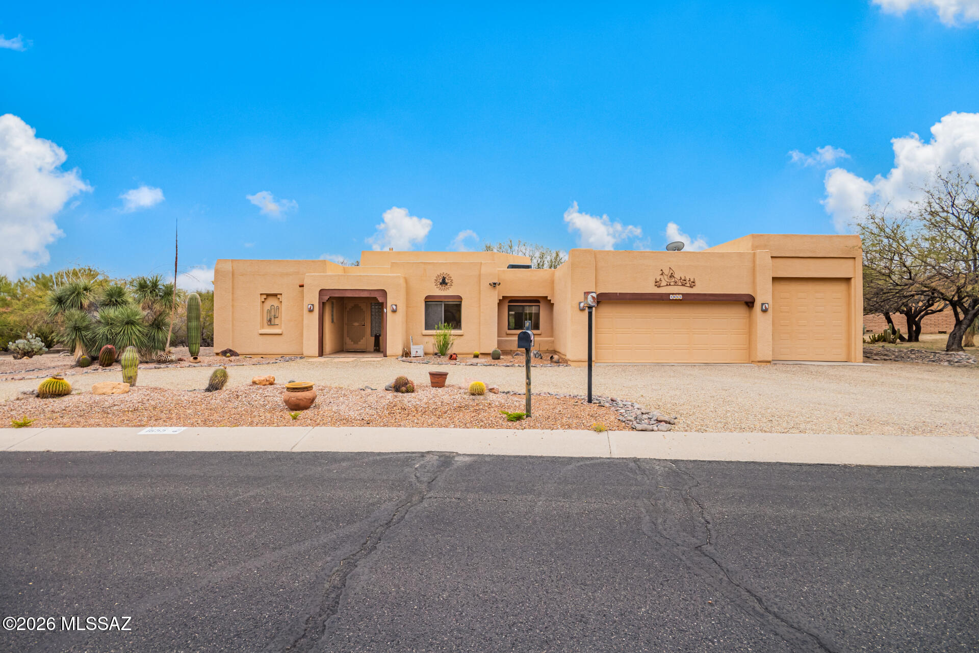 Rare opportunity on nearly half an acre in Sahuarita! This 1,935 sq ft home offers 2 bedrooms, 2 baths, plus a flexible den ideal for a home office or guest retreat. Exposed beams and a cozy fireplace create warmth and character in the main living space. The oversized 2-car garage and attached RV garage give you room for all your toys and hobbies. A heated and cooled office/storage space off the garage (not included in square footage) adds even more versatility. Enjoy space, privacy, and the freedom to live the Arizona lifestyle your way.