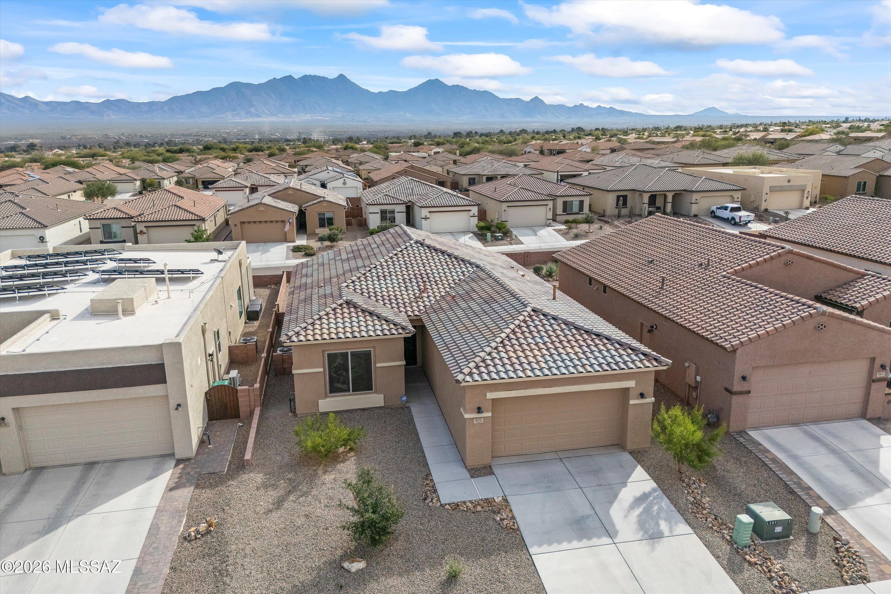 Seller will accept, or counter offers between $399,000 and $440,000. Owner/Agent - This home has prime orientation with the backyard facing beautiful Santa Rita Mountains.  Includes rear yard fence line backs to common area.  Open floor plan with no wasted space.  Includes large pantry and kitchen island, quartz countertops, cabinets with soft close doors and a full length rear patio.  One can appreciate the special evening shade, looking at the mountains.  Huge walk-in closest and dual vanities in the owners beautiful suite.  All cabinets, countertops and flooring have been upgraded for this very special designer inventory home.  Garage length has been extended by 4 feet.  2 Bedrooms with 2 full Bathrooms, plus one den/office/spare room.