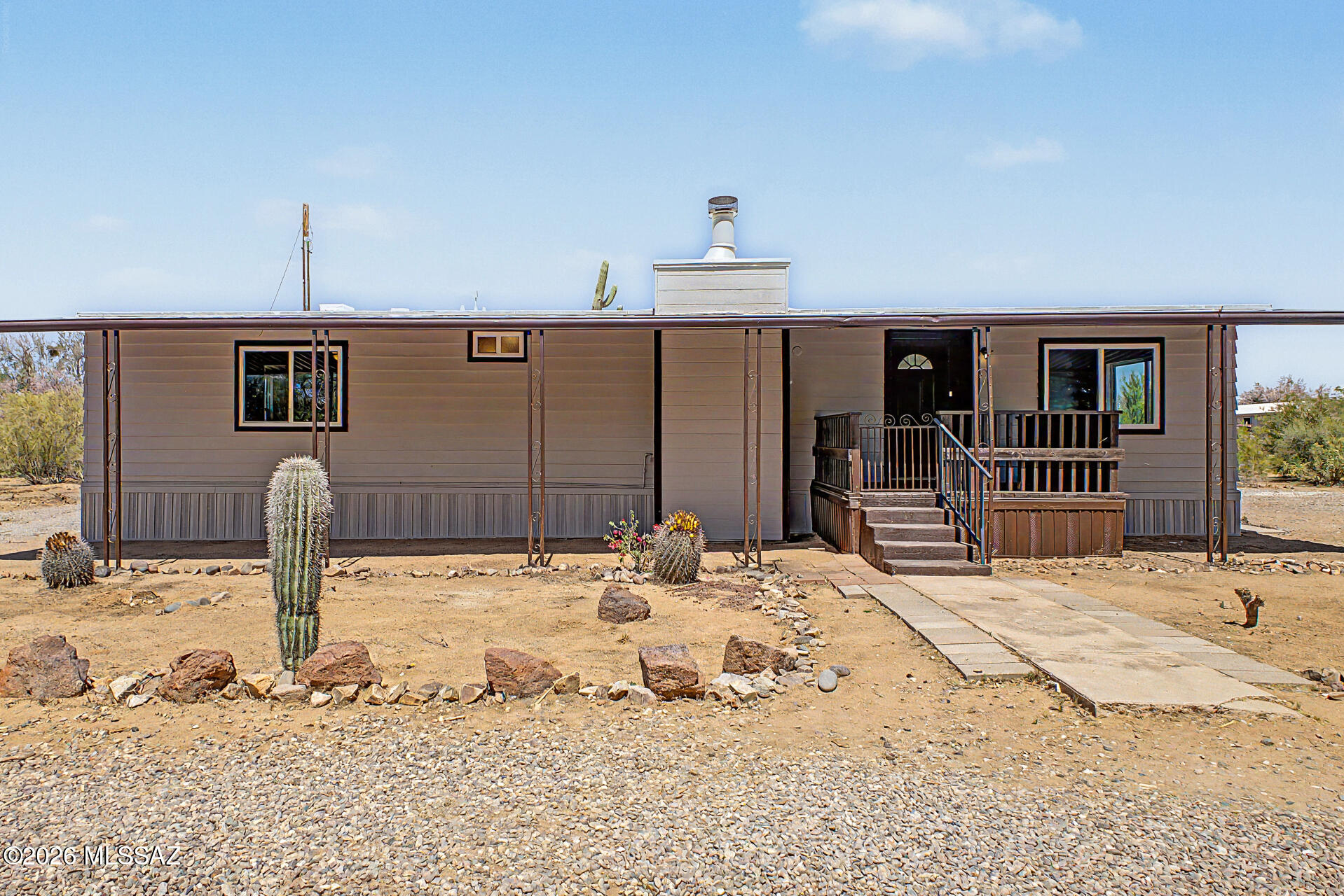 Become the proud owner of this sprawling 1.12 acre HORSE property! Discover an updated 3-bedroom, 2-bath manufactured home surrounded by a natural desert landscape. You're greeted by an inviting front porch, perfect for morning coffee or refreshing drinks. Inside, you'll find an upgraded interior featuring a serene living room w/ vaulted ceilings, a soothing palette, plush carpeting, & a fireplace for cozy evenings. The well-appointed kitchen comes w/ white shaker cabinets, a pantry, & sleek stainless steel appliances. The tranquil primary bedroom includes a private bathroom for added comfort. Unwind on the covered deck, overlooking the vast outdoor space, providing a fantastic opportunity to craft an outdoor oasis or establish equestrian facilities. Don't miss out on this one! Agent/Owner