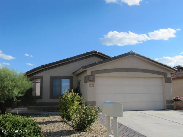Freshly painted & new wood flooring in this Beautiful Rancho Del Lago home. Free flowing, open floor plan w/huge Great Room, light & bright. Nicely upgraded, spacious kitchen w/granite slab counters, gorgeous cabinets, pantry & gas stove. Tiled in all the right areas. Large Master bath w/double sinks. Large garden tub & shower, Neutral colors. Great Mountain & Sunset views  from the front. Covered patio in back. Plenty of room in the great 4 bedroom, 2 bath home.