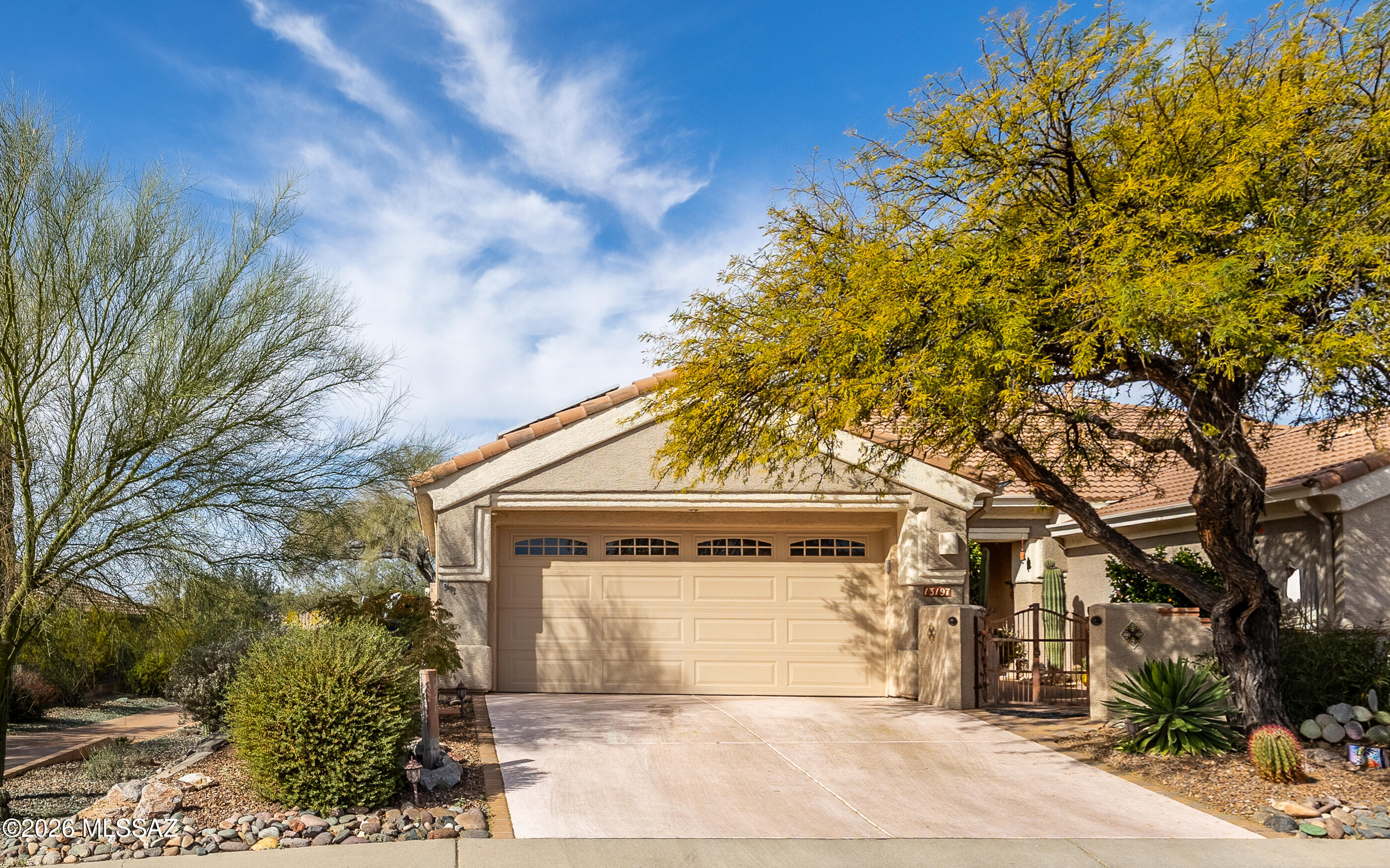 What a great location. Early Durango model - great room concept living Abundant tile flooring. Beautiful plantation shutters throughout.  There is a every so peaceful, tranquil & beautiful garden oasis gated front courtyard - great to watch the morning sunrise over the Catalina Mountains.  Backyard is comfortably oversized w/mature professionally landscaped backyard.  Home has solar system w/small balance - which can be negotiated. Very very low electric costs. This is a delightful home in a great location - popular floor plan - with great privacy.  Call for private showing.