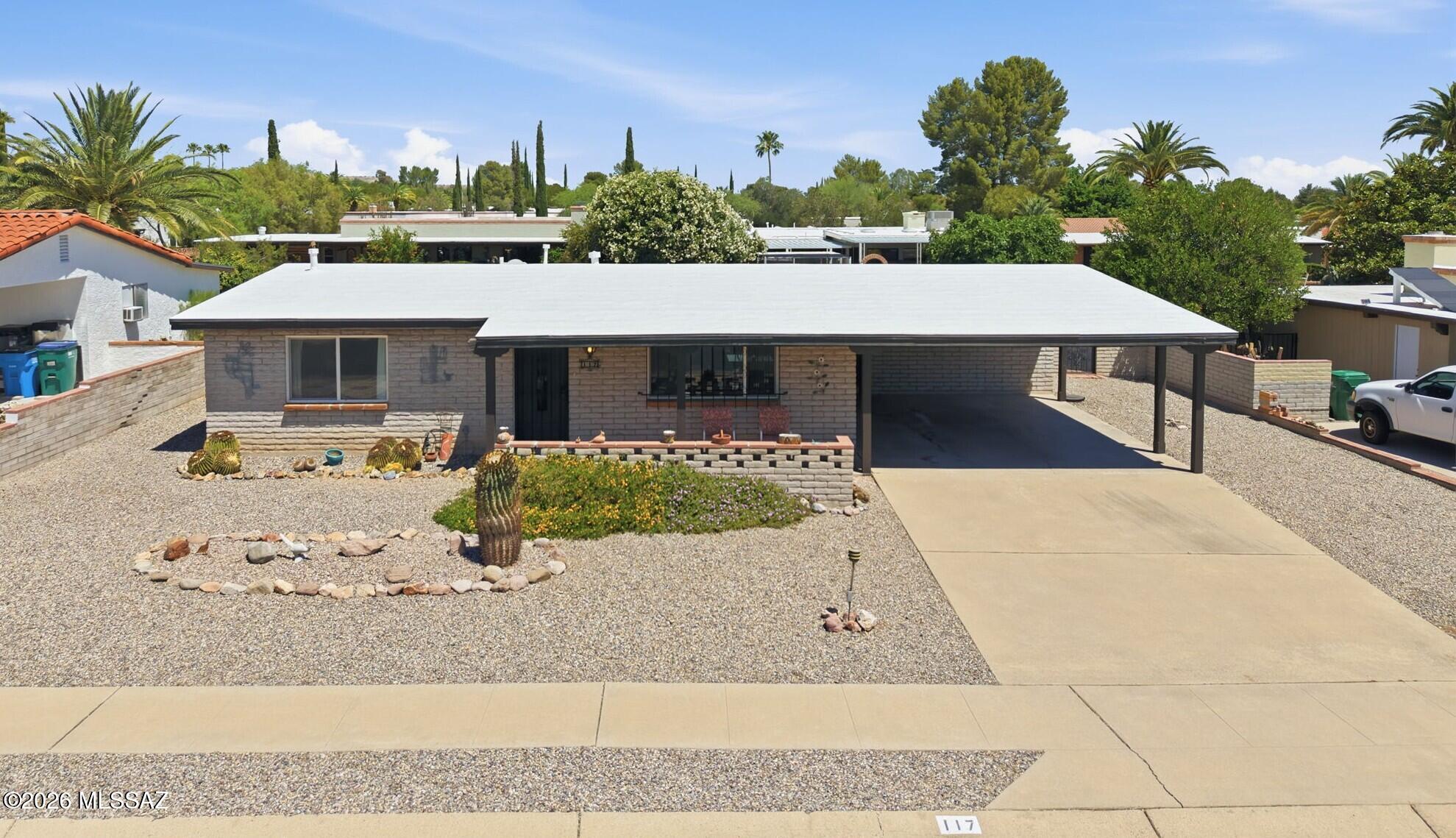 Well-maintained Southwestern slump block home built in 1972, lovingly owned by the same family since 1974 and enjoyed as a seasonal winter retreat. Located in the desirable Fairways 3 community with low HOA fees of just $60/year and wonderfully wide streets.
This 1,250 sq ft home offers 2 bedrooms, 2 baths, plus an AZ Room providing additional usable space. The property features a large 2-stall carport and is being sold furnished. 
The updated kitchen includes granite countertops, tile backsplash, newer cabinetry, a single-basin stainless steel sink with updated faucet, pantry closet, and a Pentair under-sink water filtration system with dedicated tap. A rolling butcher block island with drop-leaf extension adds flexibility and storage. Both bathrooms have been updated. The primary bath features a quartz vanity, a beautifully tiled walk-in shower with decorative accent band, pebble-stone floor, built-in niche, handheld showerhead, and grab bar. The guest bath includes a newer vanity with cultured marble and a tub/shower combo with a tiled surround.
Interior highlights include vaulted ceilings, no popcorn ceilings, and dual-pane windows (2007). Flooring consists of wood-look laminate in the main living areas, carpet in the bedrooms, luxury vinyl plank in the bathrooms, vinyl in the kitchen, and 17" glazed ceramic tile in the AZ Room. A chest freezer is included with the W/D in the laundry/storage room.
The primary bedroom features a walk-in closet. Exterior improvements include recently replaced posts for the covered front porch and carport, plus added stucco to the rear of the AZ Room for a cohesive exterior finish.
Take in mountain views from the private front porch. Enjoy outdoor living with a fully enclosed backyard featuring matching slump block walls, easy-care landscaping, a rose bush, chiminea, Weber kettle grill, and a decorative vase water fountain with electric pump. Alley access adds convenience. 
GVR membership delivers access to multiple recreation centers (pools and fitness facilities), lifelong learning opportunities, and a wide range of social and recreational activities.