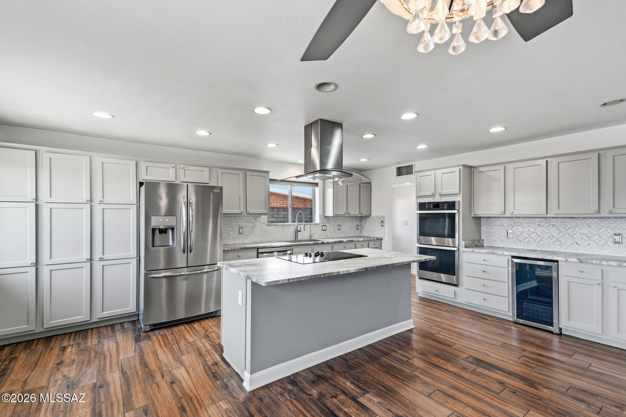 Beautifully appointed ranch-style home in desirable east-side Desert Palms Park! This bright and spacious home features a great-room concept with a split-bedroom floor plan and wood-look tile throughout the main living areas. The chef's kitchen boasts shaker-style cabinetry, quartz countertops, island, double ovens, and stainless-steel appliances. The spacious primary suite offers Catalina Mountain views, dual vanities, and a huge shower with dual showerheads. Additional highlights include a second primary suite, Jack-and-Jill bath, guest room, and den opening to the patio. Enjoy the beautifully landscaped backyard with sparkling pool, large covered epoxy-coated patio, and storage. Newer HVAC and numerous upgrades. Meticulously maintained and move-in ready!