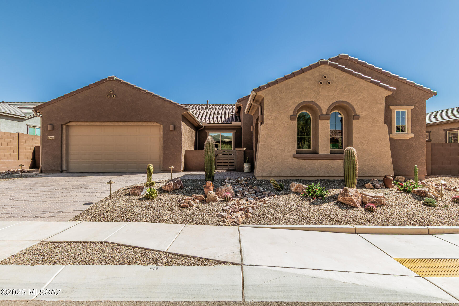 Get ready to be amazed! This stunning 2443 sq ft home with 3 bedrooms, 2 ½ baths, a den, and a 3-car garage, built in 2023, is better than new! Everything is finished and waiting for you. Step into this gorgeous retreat and start living the Arizona dream, surrounded by the breathtaking Catalina Mountains. Enjoy an impressive open floor plan with tile flooring, neutral tones, multi-sliding glass doors for seamless indoor/outdoor living. The well-equipped kitchen offers recessed and pendant lighting, a walk-in pantry, staggered cabinets w/crown molding, quartz countertops, stainless steel appliances, & quartz island w/breakfast bar. The romantic primary suite includes outdoor access, an ensuite with a glass-enclosed shower, split vanities, and a newly designed Closet Trends walk-in closet. Additionally, this home includes a dedicated den/office with a view of the front courtyard. Outside, your personal oasis awaits, complete w/a covered patio and rolling screens to create an AZ room, custom pergola w/a built-in Napoleon BBQ, & a sparkling new pool. Home is priced well below what sellers have invested in additions since it was built, just 2 years ago. Ask LA for extensive details. Don't miss this gem~~~