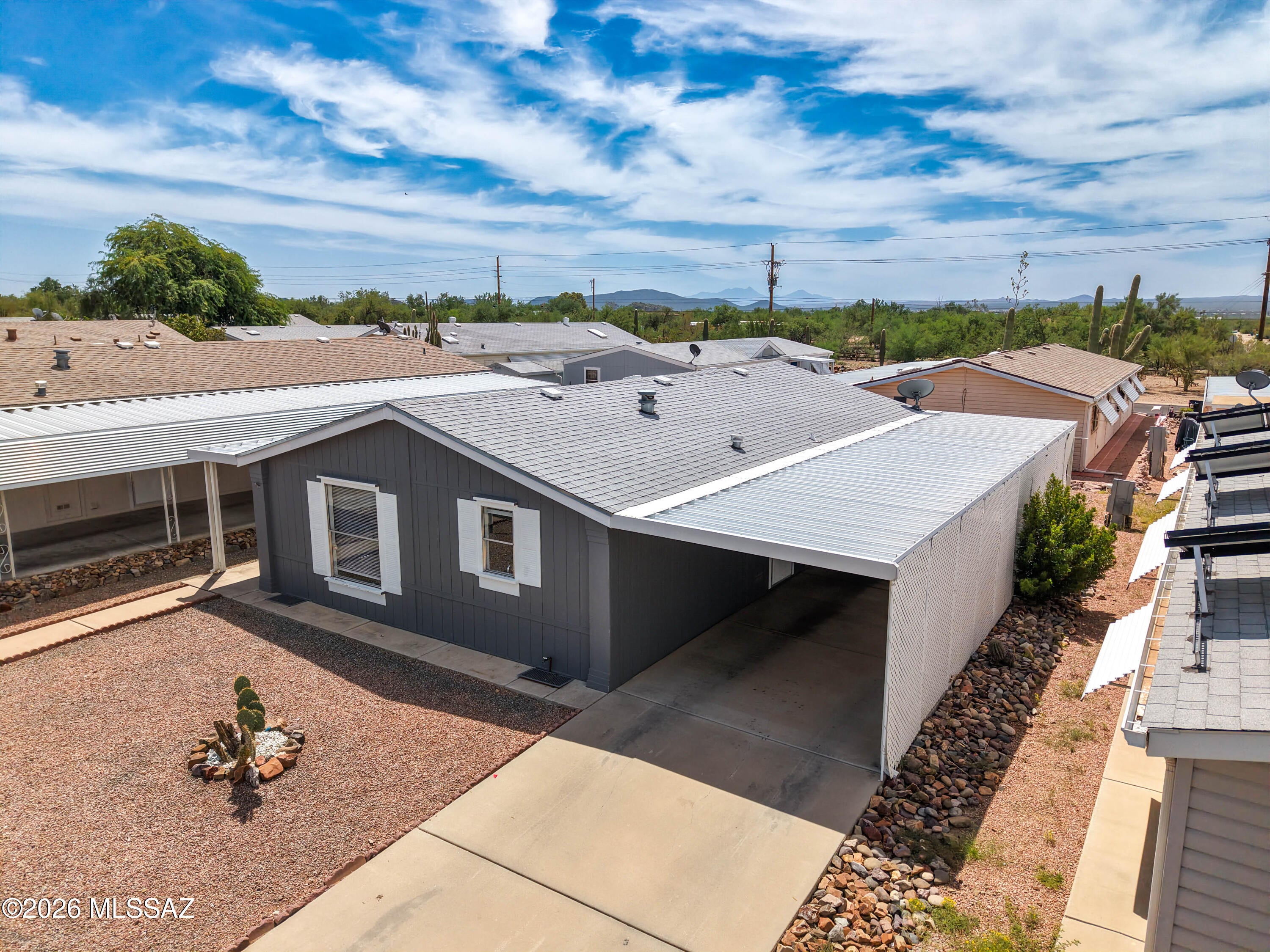 Charming 2 bed, 2 bath manufactured home offering 1,056 sq ft in a sought-after gated 55+ community on Tucson's Southwest side. This well-maintained home features wood laminate flooring, many upgrades, and a newer HVAC and Roof. Enjoy sweeping mountain views and a low-maintenance, resort-style lifestyle in a quiet, secure/gated neighborhood close to shopping, casino, Desert Museum and Old Tucson. Mon-in ready and waiting for you to make it home.