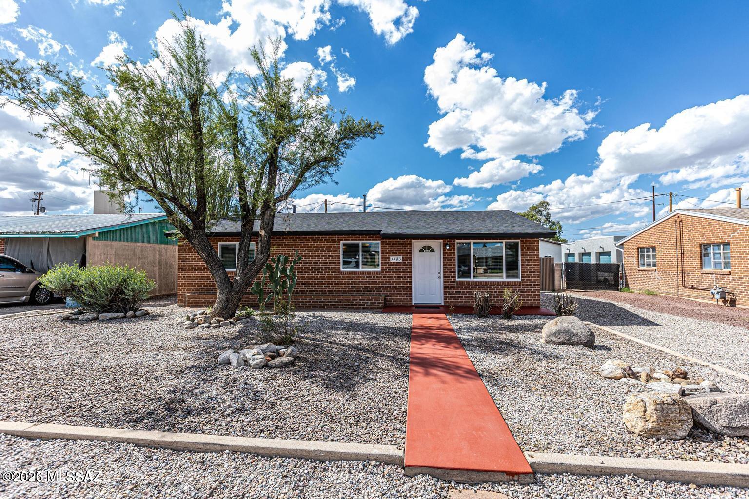 Seller will consider offers between $399,900-$427,900. Charming red brick ranch with a fully updated guest house in a fantastic midtown location! This versatile property offers two beautifully remodeled homes--perfect for next-gen living or added income potential--just minutes from shopping, dining, and everything Tucson has to offer.  The main home features 3 bedrooms and 2 bathrooms, while the guest house offers 2 bedrooms and 1 bathroom. Both units have been thoughtfully upgraded with new roofs, new A/C systems, dual-pane windows, tile flooring throughout (no carpet), custom shower surrounds, and stylish new cabinetry and countertops. Each home is also plumbed for a stackable washer and dryer.  Enjoy ample off-street parking in both the front and side, plus convenient 8' gate access to to the guest house. The spacious, fully fenced yard between the homes features raised planters, mature landscaping, cacti, and a generous covered patio--ideal for relaxing or entertaining.
Move-in ready and full of possibilities!
