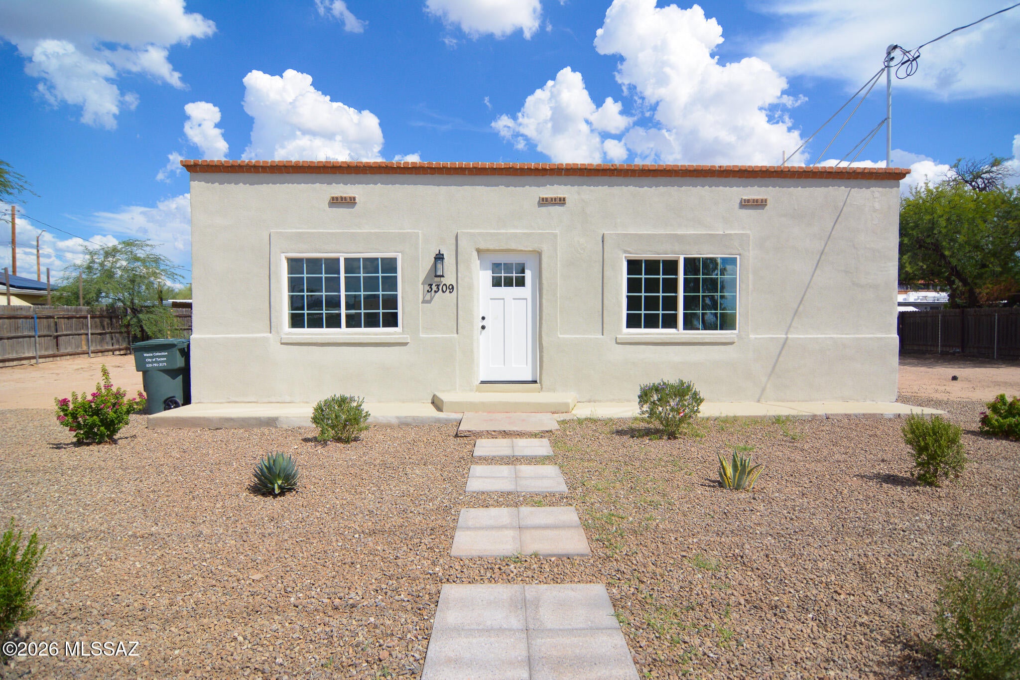 Beautifully remodeled Southwestern style home. Located in a convenient South Tucson location. Charming block construction. Rich wood look LVP flooring. Updated modern kitchen with stainless steel appliances. New custom interior and exterior paint. Updated bathrooms. Ceiling fans in each room. Large fenced yard. Mature tree. Upgraded door hardware and light fixtures. New dual pane windows, HVAC, water heater. No HOA. This home shows beautifully.
