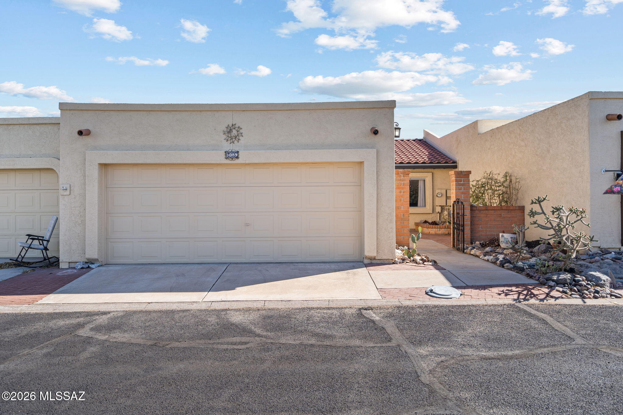 Welcome to this charming Southwestern townhouse in Green Valley's desirable Desert Hills community! This well-maintained 2BR/2BA home features classic Santa Fe architecture, a private enclosed courtyard, spacious living room with cozy beehive fireplace, and abundant natural light throughout. The kitchen offers a center island, breakfast nook, and ample storage. Tile flooring runs through the main living areas with updated luxury plank vinyl in the primary suite. Flexible Arizona room is perfect for an office, hobby space, or den. Enjoy low-care desert landscaping, covered patio, oversized 2-car garage, and access to Green Valley Recreation amenities including pools, pickleball, tennis, and fitness facilities.