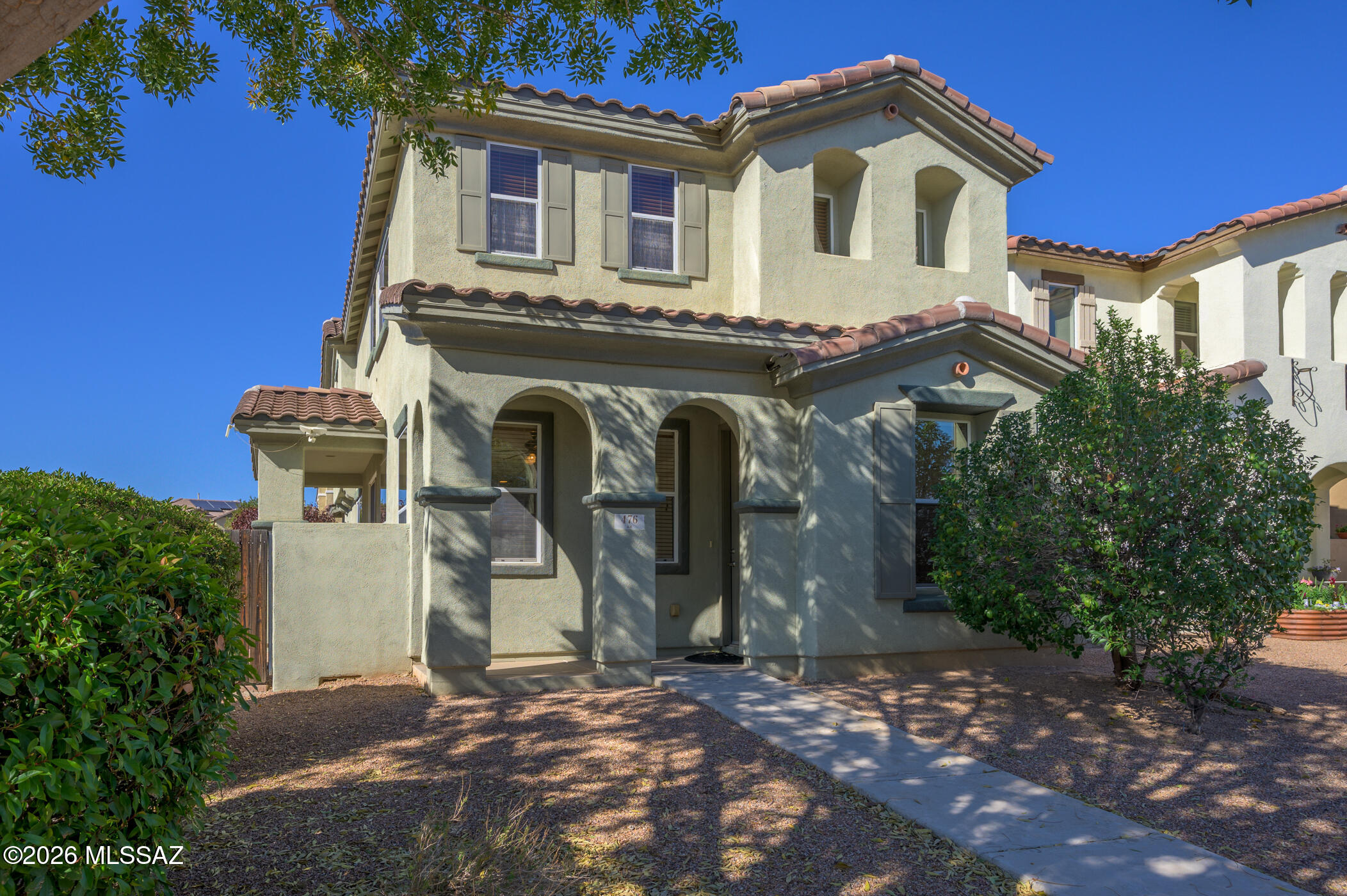 Charming and full of character, this delightful home blends playful design with a touch of country flair.  The inviting front entry, adorned with native shrubs, trees, and decorative rock, provides a warm and inviting welcome for neighbors and guests alike. Inside, the spacious open-concept main floor offers plenty of room to create a media and entertainment space.  A convenient dining area sits adjacent to a stylish serving bar, making meal delivery effortless. The kitchen features elegant cabinetry with decorative crown molding, along with beautiful granite countertops and a dual basin undermount sink, adding both functionality and a touch of luxury. Upstairs, a convenient workstation nook offers the perfect spot for business, study, or organization. The owner's suite is filled with natural light and welcomes refreshing evening cross-breezes through windows on two walls. Your primary bath includes a double vanity, a glass-enclosed shower, a relaxing soaking tub, and an oversized walk-in closet complete with built-in shelving. A comfortable guest bath comfortably serves the two additional bedrooms.  The two-car garage provides ample workspace for projects, storage, or hobbies.  Enjoy two patios ideal for relaxation or dining outdoors. The outstanding amenities of Rancho Sahuarita include a fitness center, walking trails, pools, a splash pool, parks, catch-and-release fishing, a kids' club, and much more! This is a lifestyle that fosters great friendships and lasting memories!