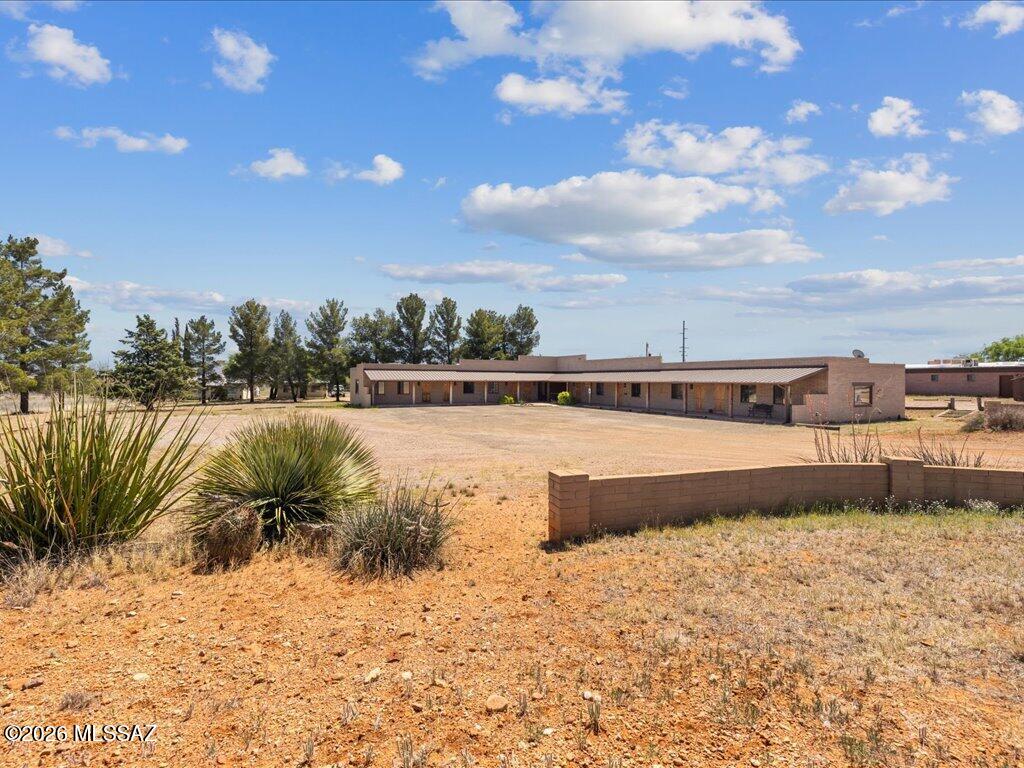 PLAZA LOS RIELES! Block Commercial 8 Unit office complex with asphalt parking. Almost a full acre with trees, storage unit, 2 common restroom, covered tiled porch in the heart of Sonoita.