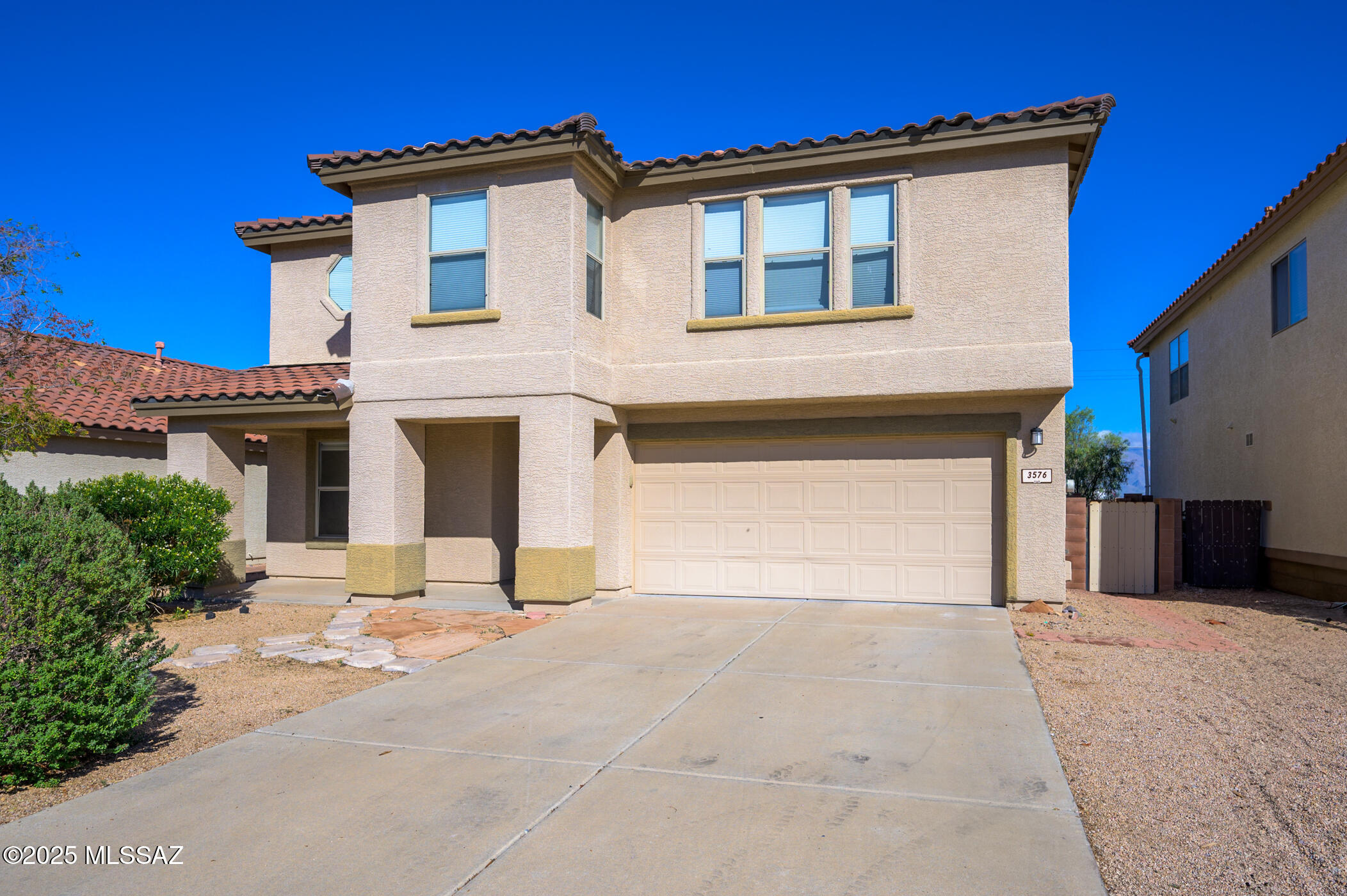 This well-maintained 4 bedroom, 3 bathroom home is located in a gated community on Tucson's west side and is positioned to capture city lights and Catalina Mountain views. The main level offers a functional layout with a living room and a family room featuring a fireplace and large windows that bring in natural light. The kitchen is generously sized with stainless steel appliances and ample cabinetry, ideal for everyday living and entertaining. Upstairs, the loft provides flexible space for a home office, media area, or additional living space. The home includes two AC units, with one replaced in 2024, offering added comfort and efficiency in a secure community.