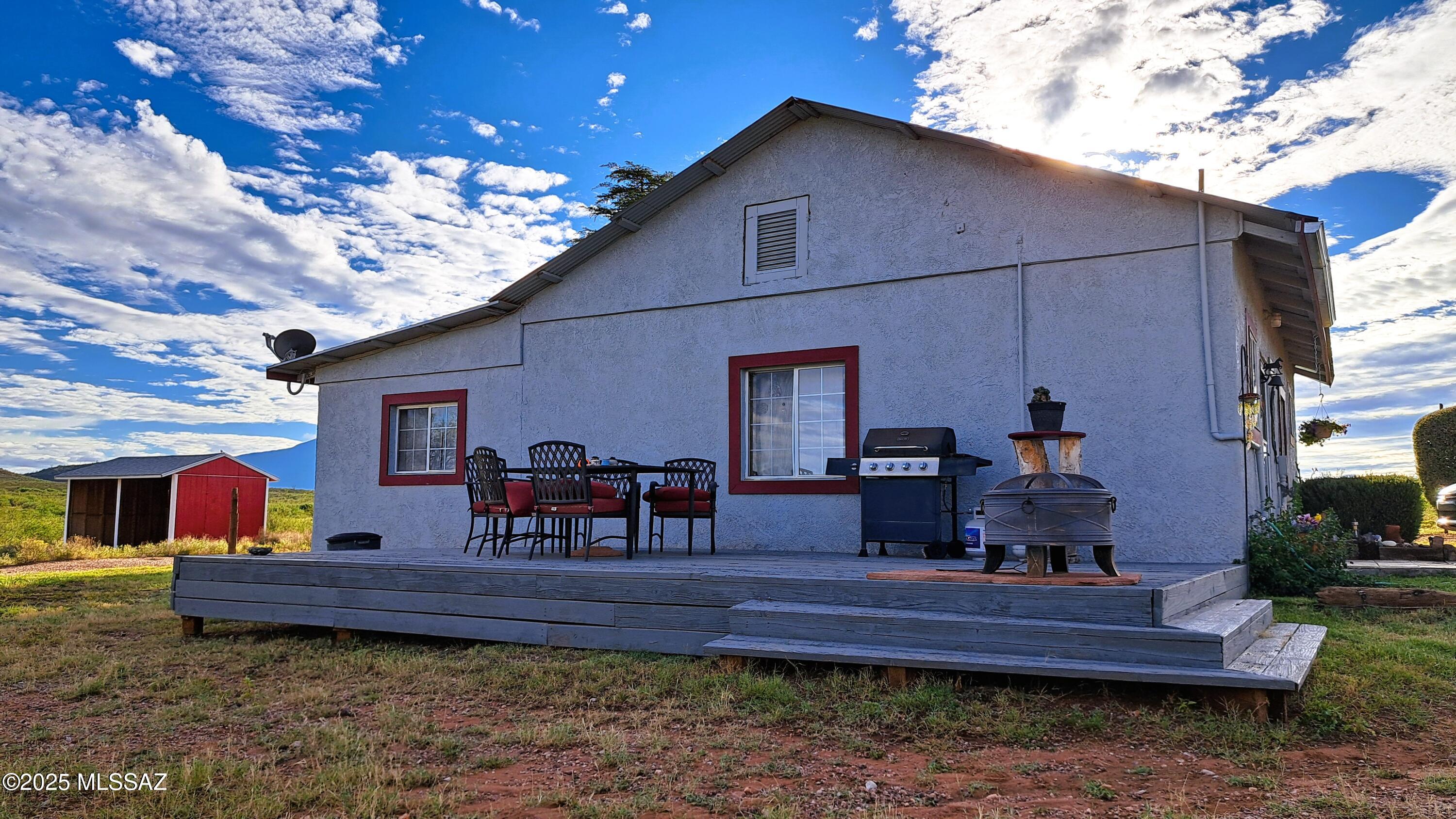 Horse property 4 miles from Bisbee's Farmer Market. Exhilarating views and the question is--''where are the neighbors.'' The vacant lots and large surrounding ranches make it so.  Plenty of creature comforts in the ranch home such as:  Central AC/Heat, dual pane windows, ceramic tile though out, updated kitchen with a ton of overhead light, butcher block counters, granite island and a deluxe gas range. The master bedroom has an attached den/ exercise room with abundant light.  A recently built 15' by 30' auxiliary building with power could easily be turned into additional living space or keep it as is-storage and separate workshop.  The 5 acres is fully fenced and gated ALSO a 3-acre cross fenced pasture with a mini barn for horses or other animals.