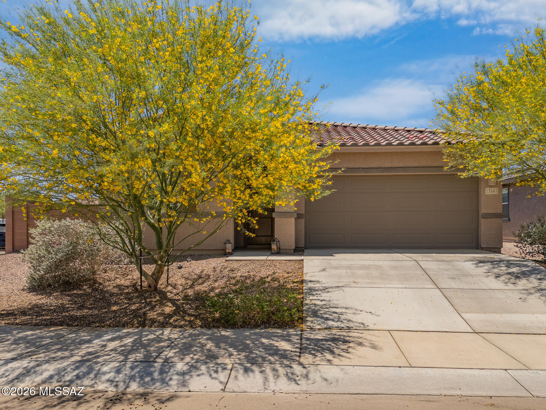 This modern home sits on a generously sized corner lot and is available fully furnished inside and out! The flexible floor plan features 4 bedrooms, including 2 with their own ensuite, and 2 living spaces. The kitchen features a large island, stainless steel appliances, and gorgeous 2 tone cabinets. All plumbing and light fixtures have been upgraded presenting a clean contemporary feel. The large primary has personalized touches including a barn door, floating cabinet, and custom painted wall. Outside features a covered patio, a large turf area, and an extended paver seating area, complete with fire pit and dining set. The spray foam insulation provides excellent energy efficiency. Situated in an ideal location in the growing Rancho Marana neighborhood, commuting and shopping is a breeze! Garage gym and all equipment, including pilates machine are available on a separate bill of sale.