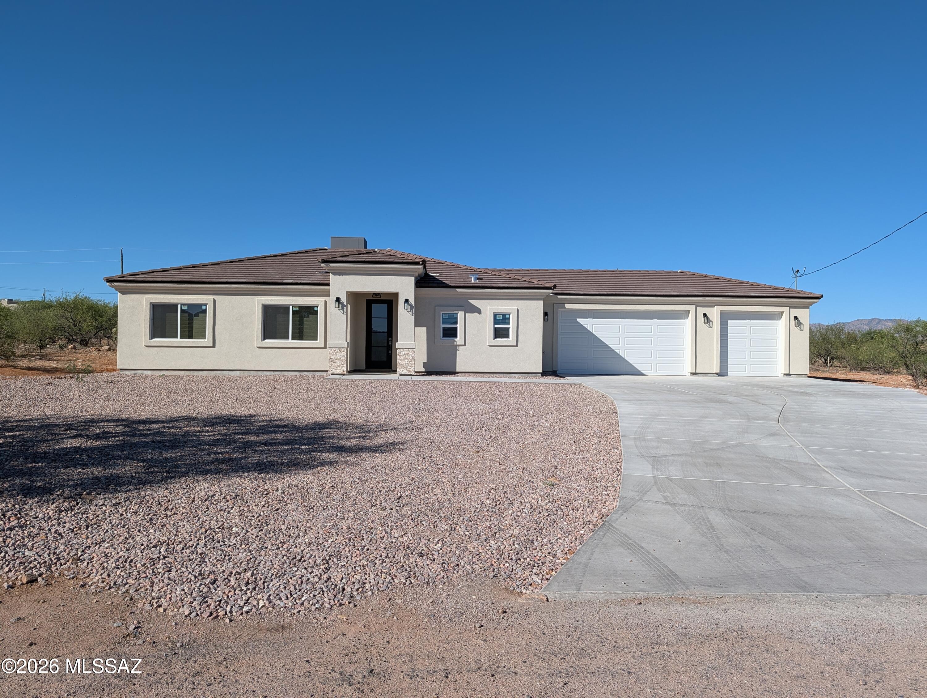 Owner / Agent - Brand new and move-in ready in Rio Rico! Situated on just over a quarter acre, this beautiful new construction home features 3 bedrooms, 2 bathrooms, and 1,486 sq ft of stylish living space. Inside, you'll find wood-look tile flooring, white cabinetry, granite countertops, stainless steel appliances, and beautifully upgraded designer bathrooms, with blinds throughout for a finished touch. The spacious 3-car garage and oversized lot offer plenty of room to spread out, while the surrounding mountain and sunset views create the perfect backdrop to enjoy Southern Arizona living. Conveniently located near Interstate 19 with quick access to shopping, dining, and schools, this move-in ready home truly checks all the boxes.