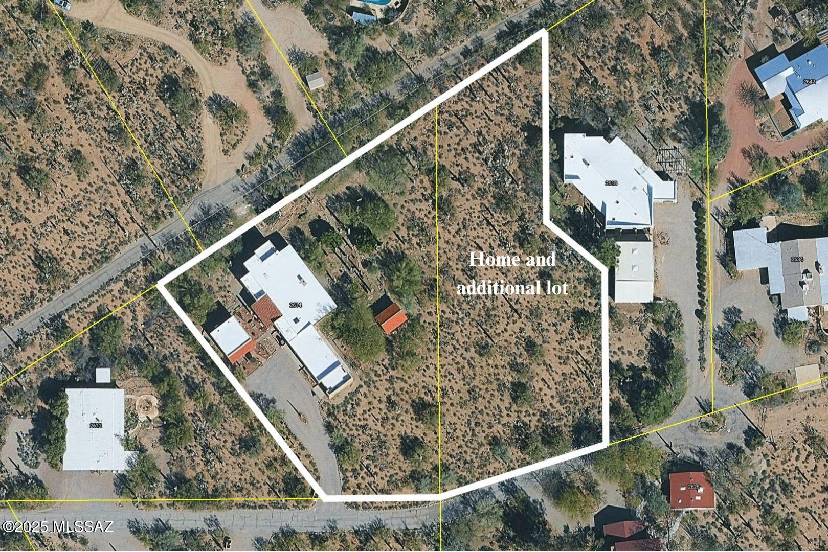 Discover comfort, versatility, and true desert serenity on this exceptional 2.02-acre Santa Fe-style estate, complete with a charming Guest House and two 1-acre contiguous lots, a rare opportunity offering enhanced privacy, future resale flexibility, or an appealing long-term investment. With NO HOA, this property invites a lifestyle defined by freedom and connection to the natural landscape.

Custom-built by its original owner, renowned for impeccable craftsmanship and perfectionist standards, the home captures authentic Southwest character. High wood-beam ceilings, rich wood floors, and expansive windows create a bright, inviting interior anchored by a dramatic stone fireplace that sets the tone for relaxed desert living. The spacious bedrooms, along with a dedicated office featuring built-in bookshelves, offer comfort and thoughtful functionality for working or unwinding at home.

The separate Guest House is a standout feature, offering visitors or extended family their own private oasis with a full kitchen, living area, and bath an ideal blend of independence and connection to the main residence.

For hobbyists and creatives, the property includes a generous workshop equipped with water and electricity, perfect for automotive projects, woodworking, crafts, or storage. Outdoor living is just as impressive, with amenities designed for both enjoyment and exploration: a BBQ hut/ramada, a peaceful cement wildlife pond, dog run with water access, horseshoe pit, basketball hoop, and meandering walkways that encourage you to roam the grounds.

The expansive patio becomes the heart of everyday living and entertaining, capturing breathtaking mountain and city views while offering unmatched privacy. Whether relaxing quietly at sunset or hosting loved ones, this space embodies effortless desert living.
All of this is just minutes from local conveniences, hiking, downtown Tucson, Starr Pass, and the University of Arizona, offering the perfect balance of tranquility and accessibility.

Price reflects the combined offering of the home and the adjacent acre. See the map in the documents section for details