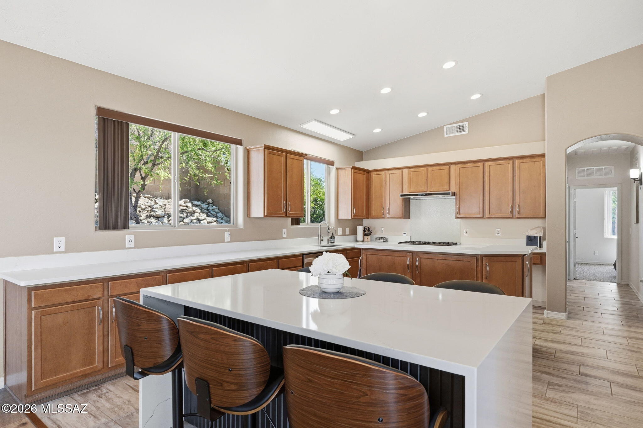 Immaculately maintained and beautifully appointed, this 2,472 sqft home in desirable gated Rancho Cancion community offers flexible living with high ceilings and lots of natural light. The updated chef's kitchen features a high-end Thermador Pro gas range, Quartz countertops, breakfast bar, conversation island, and pantry. This split bedroom plan includes 3 bedrooms plus den/office/4th bedroom. The primary suite offers a luxurious bath with heated floors, extended shower, dual sinks, granite counters, and walk-in closet plus direct patio access to the north-facing, tiered backyard with pergola kitchen area, turf grass, firepit, citrus tree, and flagstone paths. Owned solar, newer roof, water harvesting system, and 3-car garage complete this .37-acre gem near Saguaro National Monument East. THE PROPERTY
> Desirable Gated Rancho Cancion Neighborhood
> .37-acre Parcel 
> Minutes from Saguaro National Monument East
> North-Facing Enclosed Backyard
> Pergola Outdoor Kitchen Area
> Low-care Landscaping with Mature Vegetation, and Irrigation
> Water Harvesting System
> Turf Grass
> Tiered Backyard with Sitting Areas and Firepit
> Flagstone Walkways
> Tangerine Citrus Tree

THE HOME 
> Immaculately Maintained
> 2472 Square Feet of Living Area
> Flexible Space with Living and Dining Room Combination and Family Room Off Kitchen or as currently being used with Large Living Room and separate Dining Room
> High Ceilings with Lots of Windows
> Updated Chef's Kitchen with High-End Thermador Pro Natural Gas Range, Full Size Side-By-Side Refrigerator/Freezer unit, Quartz Countertops, Breakfast Bar, Conversation Island, and Pantry Closet
> Split Bedroom Plan
> 3 Bedrooms plus Den/Office/4th Bedroom
> Primary Bedroom Suite has Direct Access to Covered Patio and Backyard
> 2 Bathrooms
> Spacious Primary Bathroom has Heated Floors, a Custom Extended Shower, Dual Sinks, Granite Countertops, and a Large Walk-in Closet
> Guest Bathroom has Dual Sinks, Tub/Shower Combo and Granite Countertops
> Shade Screen at Front Entrance
> Front Door Keypad Locking System 
> Covered Patio
> Spacious 3-Car Attached Garage 
> Owned Solar Electric System
> Water Softener & Reverse Osmosis
> Newer Roof