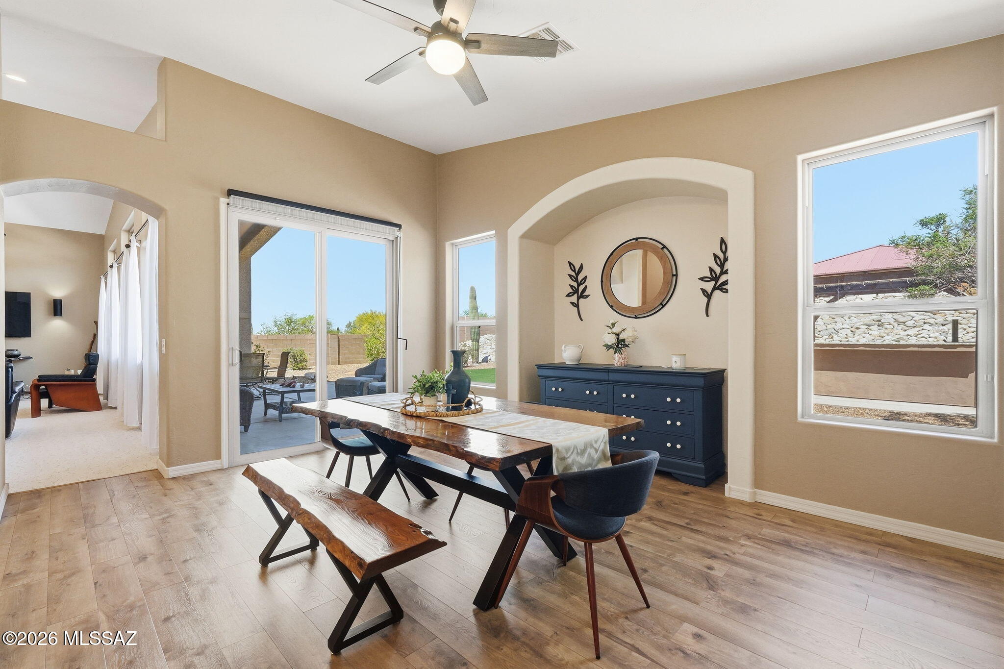Immaculately maintained and beautifully appointed, this 2,472 sqft home in desirable gated Rancho Cancion community offers flexible living with high ceilings and lots of natural light. The updated chef's kitchen features a high-end Thermador Pro gas range, Quartz countertops, breakfast bar, conversation island, and pantry. This split bedroom plan includes 3 bedrooms plus den/office/4th bedroom. The primary suite offers a luxurious bath with heated floors, extended shower, dual sinks, granite counters, and walk-in closet plus direct patio access to the north-facing, tiered backyard with pergola kitchen area, turf grass, firepit, citrus tree, and flagstone paths. Owned solar, newer roof, water harvesting system, and 3-car garage complete this .37-acre gem near Saguaro National Monument East. THE PROPERTY
> Desirable Gated Rancho Cancion Neighborhood
> .37-acre Parcel 
> Minutes from Saguaro National Monument East
> North-Facing Enclosed Backyard
> Pergola Outdoor Kitchen Area
> Low-care Landscaping with Mature Vegetation, and Irrigation
> Water Harvesting System
> Turf Grass
> Tiered Backyard with Sitting Areas and Firepit
> Flagstone Walkways
> Tangerine Citrus Tree

THE HOME 
> Immaculately Maintained
> 2472 Square Feet of Living Area
> Flexible Space with Living and Dining Room Combination and Family Room Off Kitchen or as currently being used with Large Living Room and separate Dining Room
> High Ceilings with Lots of Windows
> Updated Chef's Kitchen with High-End Thermador Pro Natural Gas Range, Full Size Side-By-Side Refrigerator/Freezer unit, Quartz Countertops, Breakfast Bar, Conversation Island, and Pantry Closet
> Split Bedroom Plan
> 3 Bedrooms plus Den/Office/4th Bedroom
> Primary Bedroom Suite has Direct Access to Covered Patio and Backyard
> 2 Bathrooms
> Spacious Primary Bathroom has Heated Floors, a Custom Extended Shower, Dual Sinks, Granite Countertops, and a Large Walk-in Closet
> Guest Bathroom has Dual Sinks, Tub/Shower Combo and Granite Countertops
> Shade Screen at Front Entrance
> Front Door Keypad Locking System 
> Covered Patio
> Spacious 3-Car Attached Garage 
> Owned Solar Electric System
> Water Softener & Reverse Osmosis
> Newer Roof