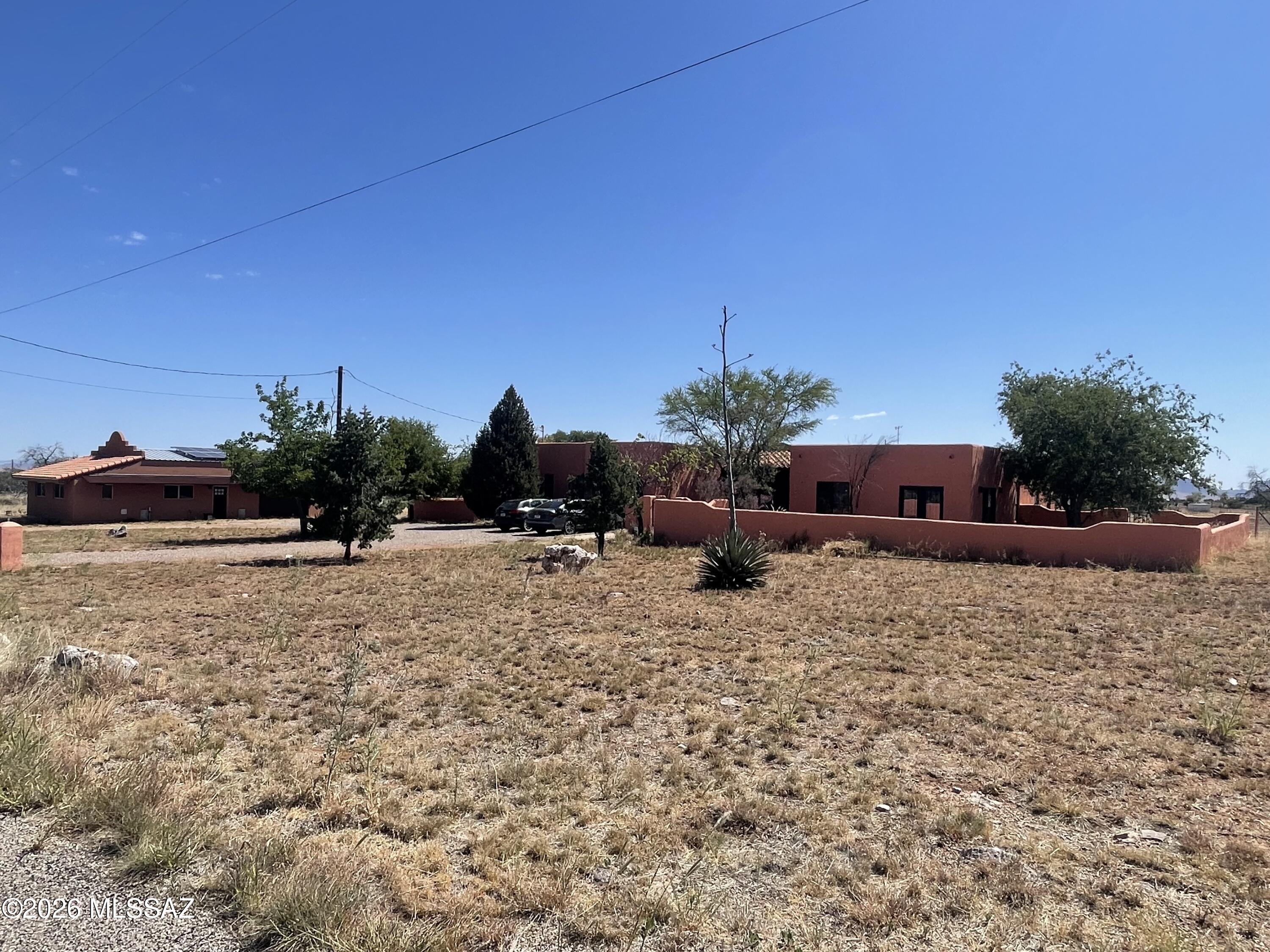 Spacious Santa Fe home in a quiet neighborhood. 5,000' elevation, high-desert grasslands & oak trees, minutes away from town center, wineries, Nat'l Forest and so much more. Home features 3 Bdr & 2 bonus rooms, one of the bonus rooms can be made into private guest quarters or used for extra income as a rental, Primary suite is very spacious w/walk-in closet, new windows, engineered wood floors & newly remodeled Bath. Ceramic tile throughout main house, High ceilings, Kitchen Island, tile countertops, SS appliances, & lots of extra storage, pantry, & huge laundry room. Outbuilding can be made into a guest house, A 1,200 Sf detached Garage/Shop, 6.3 kW Solar system, it powers the whole house to keep electric bills very low! New steel fencing for horses or farm animals, Come see this gem!