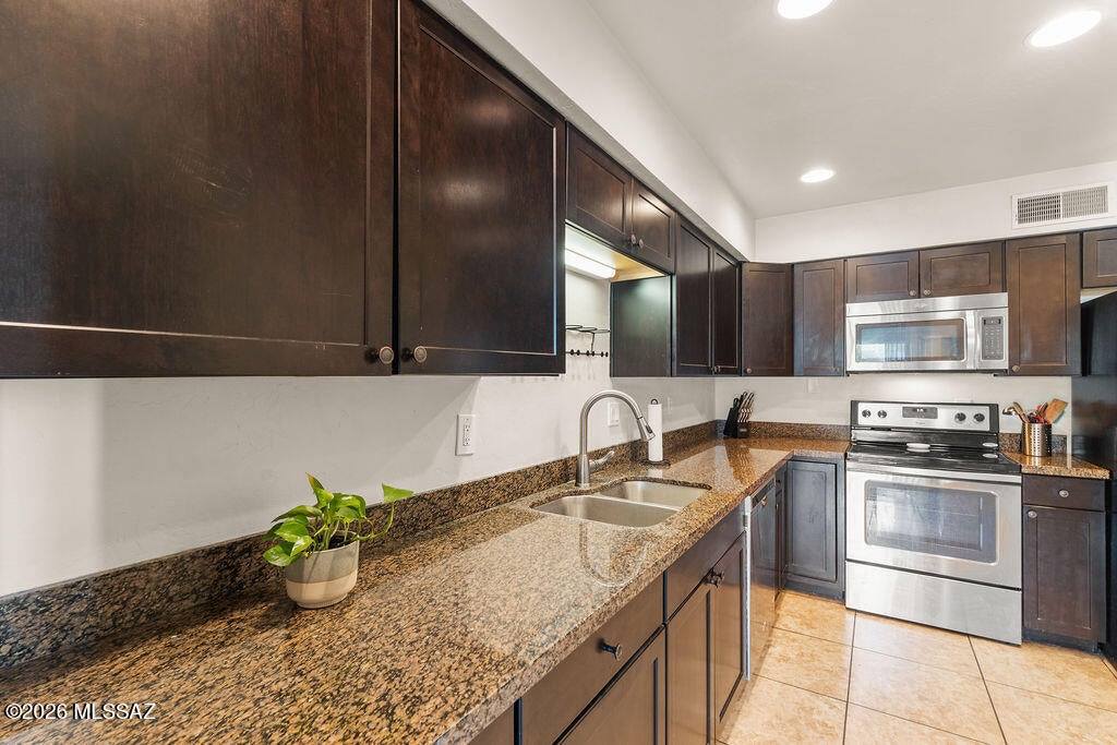 Seller will accept/counter offers between $217,000-$225,000. Head upstairs to find all three bedrooms plus a full hall bath. The north-facing primary suite is a true retreat, boasting vaulted ceilings, a clerestory window, a walk-in closet, an en-suite bath with executive-height counters, and a private balcony offering peek-a-boo mountain views. Bedrooms 2 and 3 (the latter oversized) each catch a glimpse of those mountain views as well, and both upstairs bathrooms shine with handsome tile surrounds and plenty of counterspace. The HOA keeps this community in top shape--recently replacing the tile roof, coating the flat roof section, and resurfacing the streets. Beyond roof and street maintenance, your HOA dues also cover water, sewer, trash, and access to TWO pools for endless summer fun! A one-car attached carport with its own storage closet completes the package. Location-wise, you're close to I-10 and downtown, yet wrapped in gorgeous, serene desert scenery--with Tumamoc Hill, A-Mountain, Greasewood Park, Starr Pass, and Painted Hills trails all just minutes away.