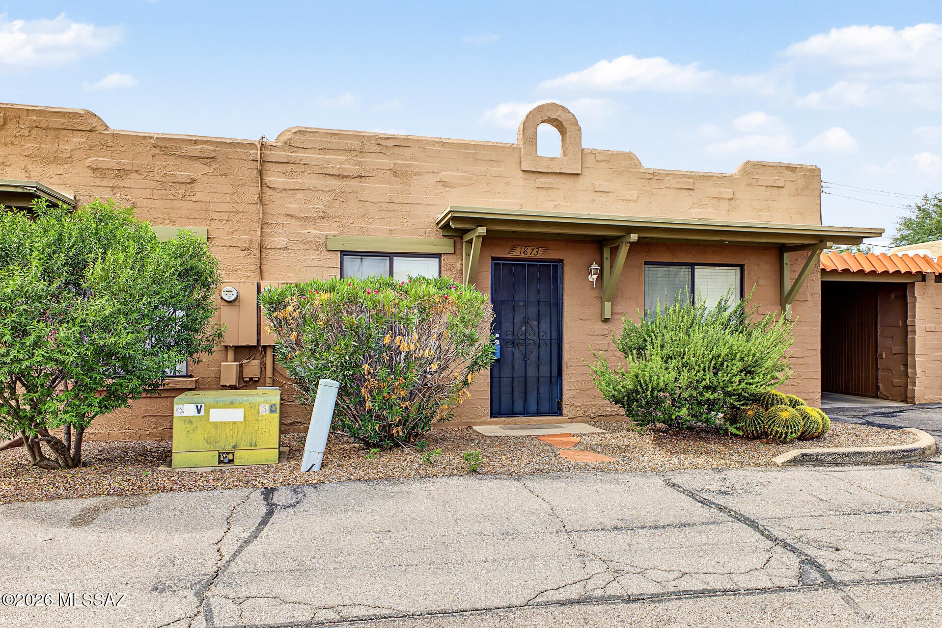 Welcome to this move-in-ready townhome tucked away in a quiet, centrally located community! Ideally situated toward the back of the community, this home is just an easy walk to the sparkling community pool. Features include a one-car carport with a large storage closet, plus a separate laundry room with a washer and dryer less than two years old. Inside, you'll find tile flooring, stainless steel appliances, ceiling fans, updated window treatments, and an inviting great room with an adobe-style fireplace. All windows have been replaced, and the HVAC system was updated just two years ago. Enjoy the covered back patio and high privacy fence--perfect for relaxing or letting your little dog enjoy the outdoors. A must-see!
