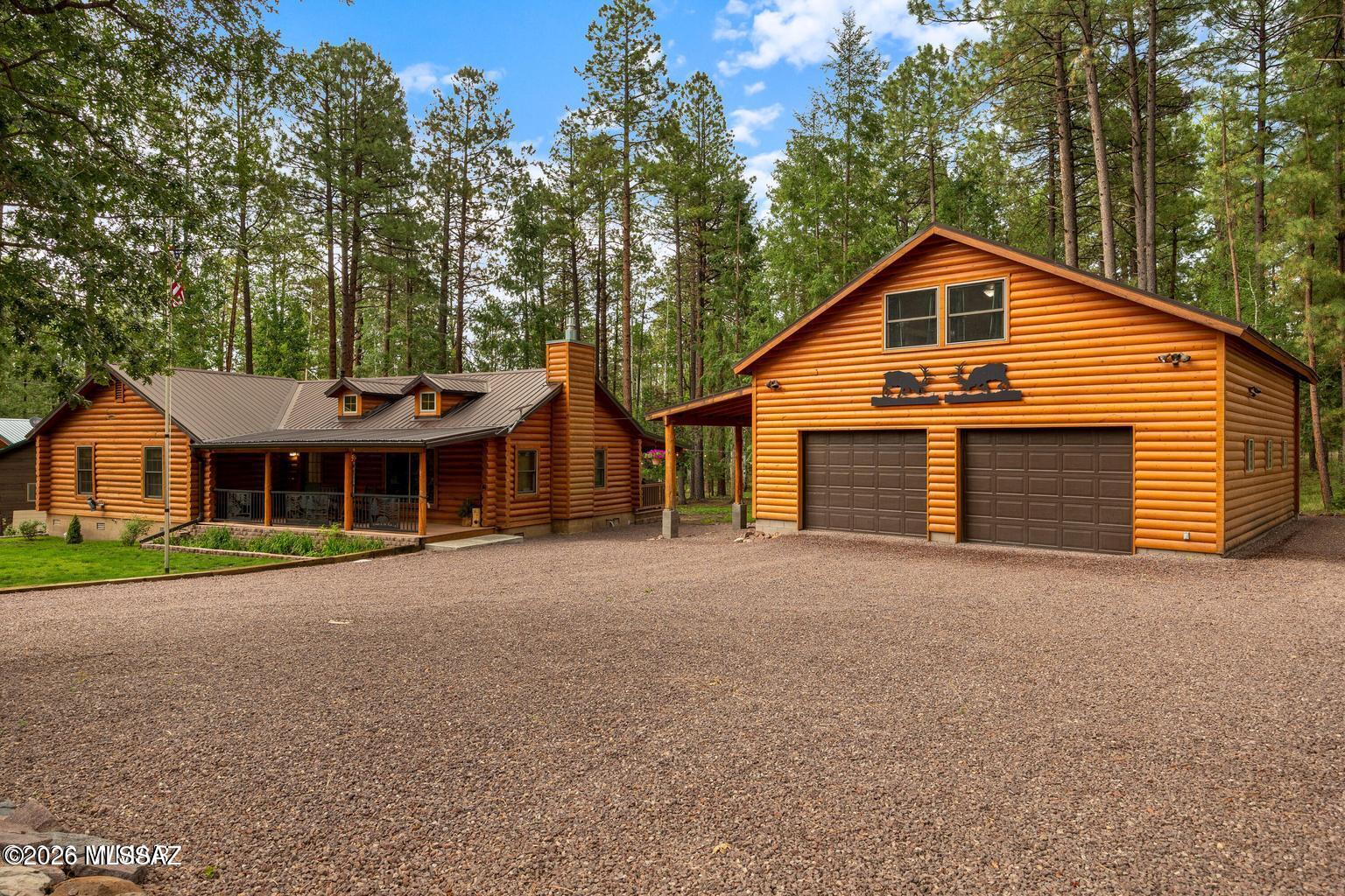 A beautifully updated main home, and a private studio apartment over a detached garage.--this one-of-a-kind Alpine retreat offers flexibility, comfort, and tranquility at its finest!The main residence features three bedrooms, two bathrooms, an inviting open great-room floor plan, and a cozy propane fireplace for chilly mountain evenings. The kitchen offers abundant storage, charming cabinetry, a new backsplash, freshly painted cabinets, and a brand-new appliance package, including an induction range with convection and air-fry capabilities. Recent improvements include new interior paint, professionally chinked interior log walls, new LVP flooring in the common areas, stain-resistant bedroom carpeting, updated toilets and plumbing fixtures, and mini-split systems in the primary bedroom and main living area for efficient heating and air conditioning. The primary suite also features a newly created walk-in closet with a barn door. An ETS heater provides additional energy-efficient warmth near the bedrooms.
A detached, heated two-car garage includes workshop space and a full studio apartment above with its own private stairway entrance--ideal for guests, extended family, a home office, or additional living space. A regularly serviced chair lift provides convenient access to the loft. Custom illuminated elk accents add character to the garage exterior.

Outside, the beautifully landscaped grounds are filled with healthy aspen, oak, and juniper trees. Property boundaries have been professionally surveyed and are clearly defined with decorative rock borders. Enjoy the custom porch railing featuring a forest and wildlife scene, secure gravel pathways throughout the property, café lighting, and a built-in propane fire pit that can be enjoyed year-round, even during burn restrictions.

Garden enthusiasts will appreciate the protected garden enclosure, eight raised beds filled with natural composting material, and an outdoor hot-and-cold-water sink near the garage--perfect for gardening or cleaning freshly caught fish. The property has been carefully maintained, with unhealthy trees professionally removed as needed.

Every improvement was completed with long-term comfort, efficiency, and reduced maintenance in mind. The pride of ownership is evident throughout this exceptional property. Alpine is known for world-class hunting and fishing, hiking and biking trails, lakes, rivers, and streams, with Sunrise Park Resort nearby for year-round recreation.