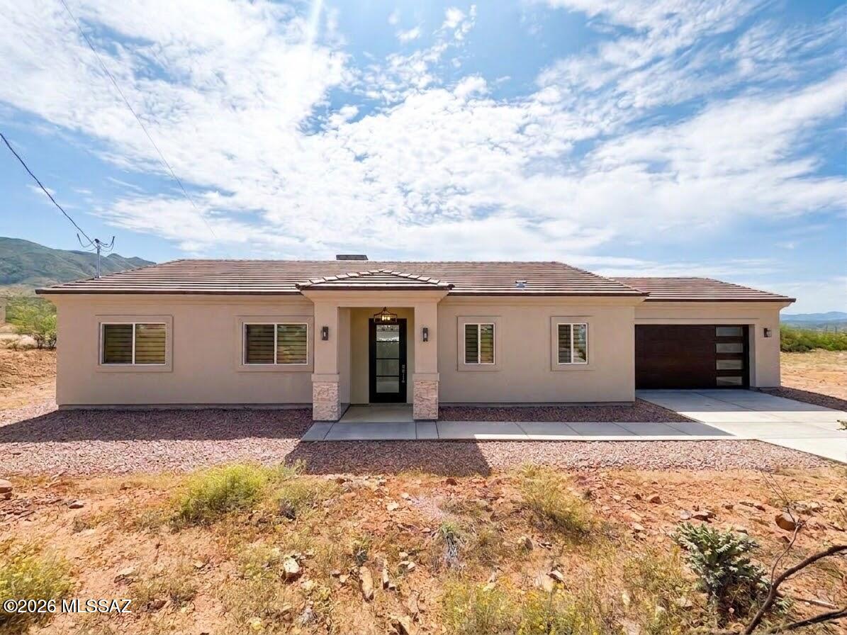 Owner-Agent - Brand-new construction in Rio Rico, ready for its new owners! This beautiful single-story home offers 3 bedrooms, 2.5 bathrooms, a 2-car garage, and a concrete driveway. Inside, enjoy wood-look tile throughout, blinds, ceiling fans, and TV mounts already in place. The spacious upgraded kitchen features a large island, white cabinetry, granite countertops, and stainless steel appliances. Additional highlights include built-in storage cabinets in the laundry room, custom closet built-ins in the primary suite, and large walk-in showers. Fresh, modern, and completely move-in ready!