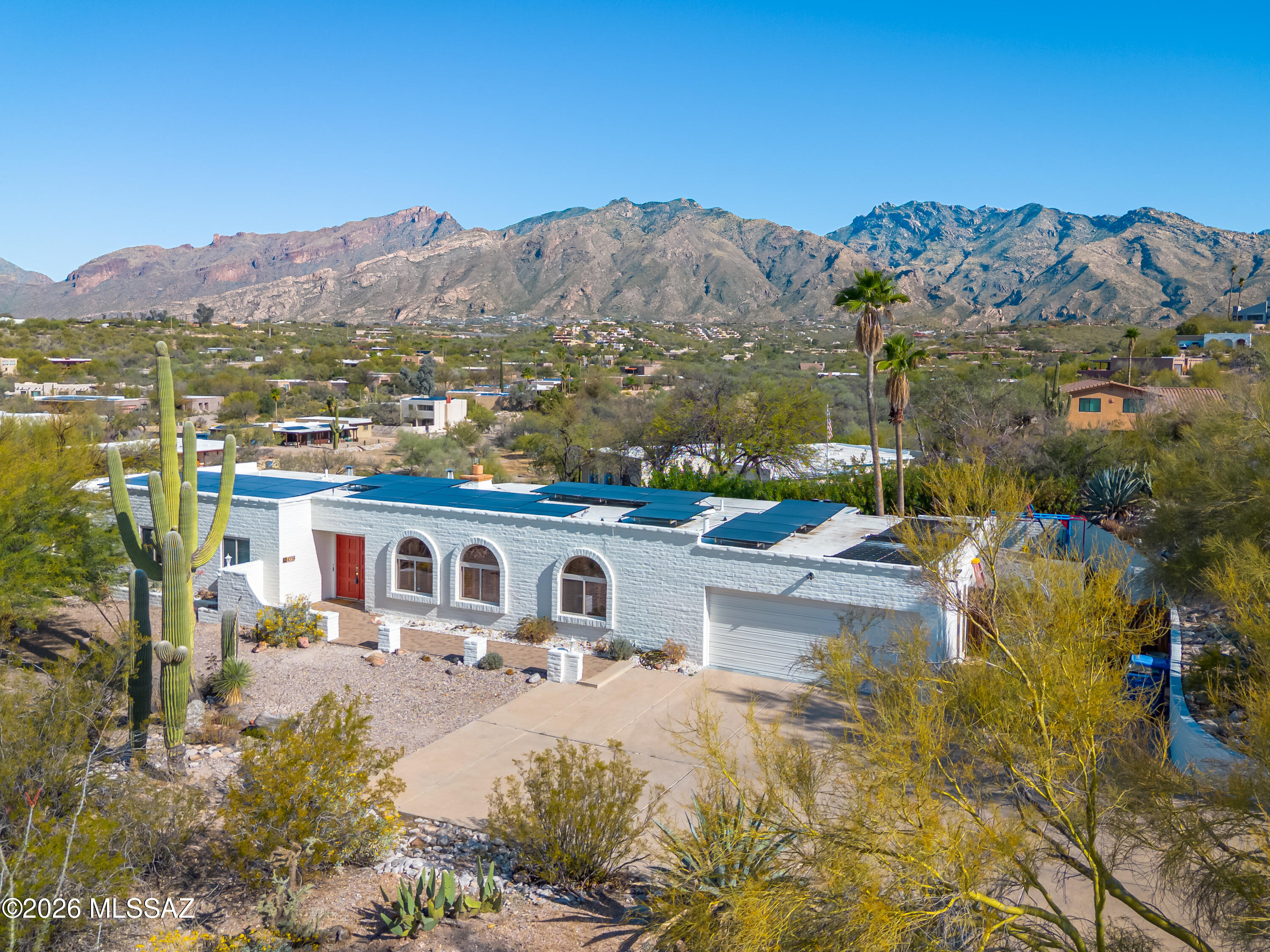 Experience the perfect blend of comfort, character & desert beauty in this stunning Territorial-style home in the heart of Sunrise Presidio Village. Set on an expansive .62-acre lot at the end of a quiet, non-through street, this 2,322sf 4BR/2 ½ BA bath home offers privacy, space & breathtaking mountain views in one of Tucson's most desirable northeast locations. Spacious kitchen features a large center island, gas range, stainless appliances & generous storage ideal for both daily living & entertaining. Living & dining spaces feel warm & welcoming, while the family room is anchored by a charming beehive fireplace, creating the perfect gathering spot. Primary suite is a true retreat, offering a spa-like bath w/dual vanities, soaking tub, expansive walk-in shower & custom closet. Glass slider to private flagstone patio. Blackout rolling shutters provide complete light control. Three additional bedrooms allow flexibility for guests, home office or hobbies. Situated in a resort-inspired backyard designed for both relaxation & play w/recently refinished sparkling pool, lush mature landscaping, flagstone walkways & peaceful desert & mountain views. Turf play area, garden spaces & access to the natural wash complete this exceptional outdoor experience. Additional highlights include an insulated two-car garage w/extensive cabinetry, epoxy floors, Tesla solar panel suite & workshop space. Recent updates include roof coating, newer HVAC, water heater, exterior paint & owned solar system for the home and solar coils for the pool. Low HOA dues $825 annually. Perfectly positioned in Tucson's coveted Catalina Foothills, this home enjoys close proximity to Sabino Canyon Recreation Area, offering world-class hiking, biking, and breathtaking desert scenery just minutes away. Residents also love the easy access to upscale shopping, dining, and entertainment as well as nearby golf courses, scenic walking paths & everyday conveniences.