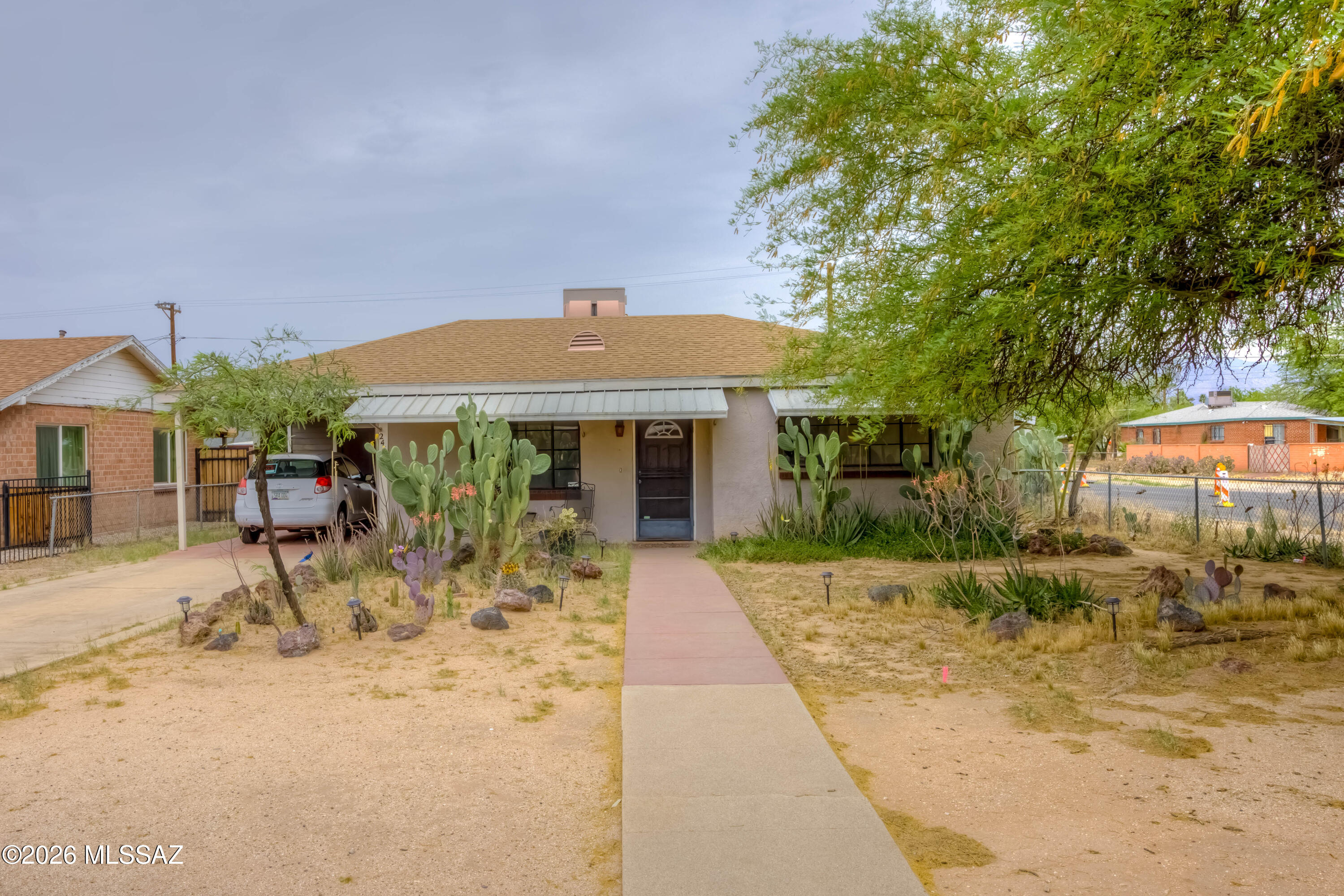 Range Pricing. Seller to accept/counter offers $225,000-$240,000. Estate Sale. Discover the charm of this delightful 2-bdrm, 1-bath bungalow-style home, perfectly situated on a spacious corner lot. Step inside to find a freshly painted interior with laminate flooring in the living, kitchen & and bath areas & carpeted bedrooms for ultimate comfort. With an attached carport, laundry/storage room, enjoy partial mountain views, a stand-alone storage shed, & ample room for outdoor living, gardening, or pursuing your favorite hobbies. The gated entrance to the backyard adds both accessibility & privacy, making the outdoor space truly versatile. Conveniently located near shopping, dining, the U of A, & Reid Park, this home offers the perfect blend of charm, convenience & possibilities.