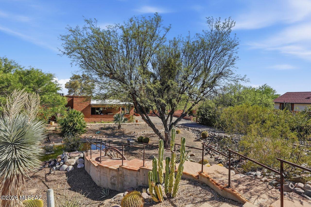 Set on 1.43 acres in Tucson, this 1977 adobe brick ranch home blends timeless Southwest character with modern comfort. Tucked away on a quiet cul-de-sac, the 3-bedroom, 2-bath layout showcases breathtaking mountain and sunset views. Inside, the updated kitchen features stainless steel appliances, while Saltillo tile flooring adds warmth and charm throughout. Both bathrooms have been tastefully updated for a fresh, inviting feel. Outside, a covered patio extends across three-quarters of the rear of the home and overlooks the sparkling pool - an ideal setting for entertaining or relaxing on Arizona evenings. Additional upgrades include a newer heat pump, tankless water heater, 2-panel doors, updated outlets, new baseboards, and a replastered pool. This home is a MUST SEE! Call now!