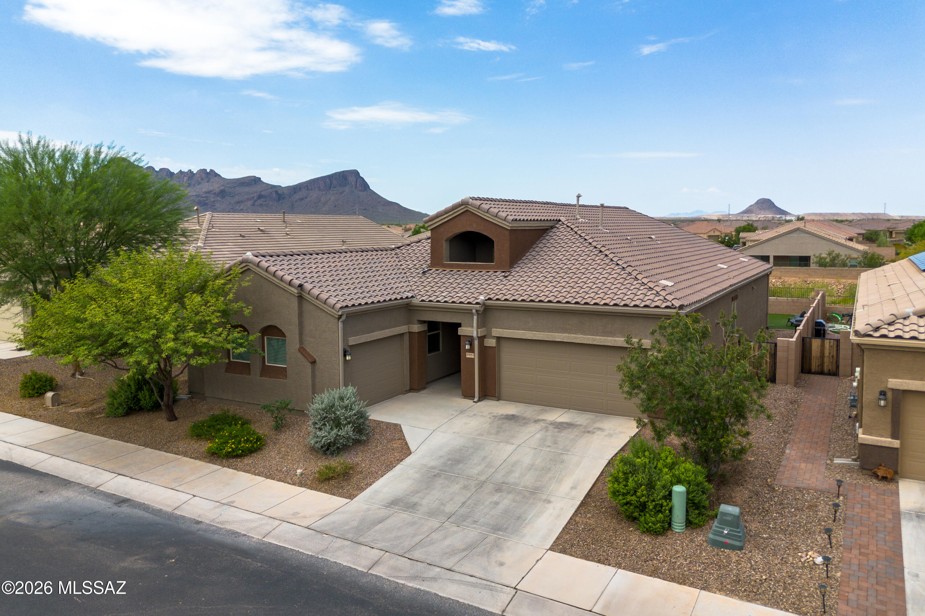 Located in the sought after Saguaro Bloom community, this home is one you need to see in person. From the moment you walk through the front door, you're welcomed by soaring 16 foot ceilings, an abundance of natural light, and an open floor plan that makes the entire home feel bright and inviting. This home has been exceptionally well cared for and is packed with thoughtful upgrades throughout. The kitchen is the heart of the home and features quartz countertops, an oversized island, upgraded cabinetry, a beautiful backsplash, a gas cooktop, convection oven, and a spacious walk in pantry that makes both everyday living and entertaining effortless. Need extra space? The bonus den gives you endless possibilities and can easily be used as a home office, playroom, media room, or workout space. The primary retreat features two separate vanities, a walk in shower, and a generous walk in closet. Two of the additional bedrooms are connected by a Jack and Jill bathroom, while the fourth bedroom is perfect for guests or multigenerational living with easy access to the third full bathroom. Even the laundry room was thoughtfully designed with a built in backpack drop zone and an additional storage closet. Outside, you'll find a beautifully landscaped backyard with lush turf that stays green year round and no rear neighbors, giving you extra privacy to relax or entertain. Add in the three car garage, tall ceilings, oversized windows, and the incredible condition of this home, and it's easy to see why this one stands out.