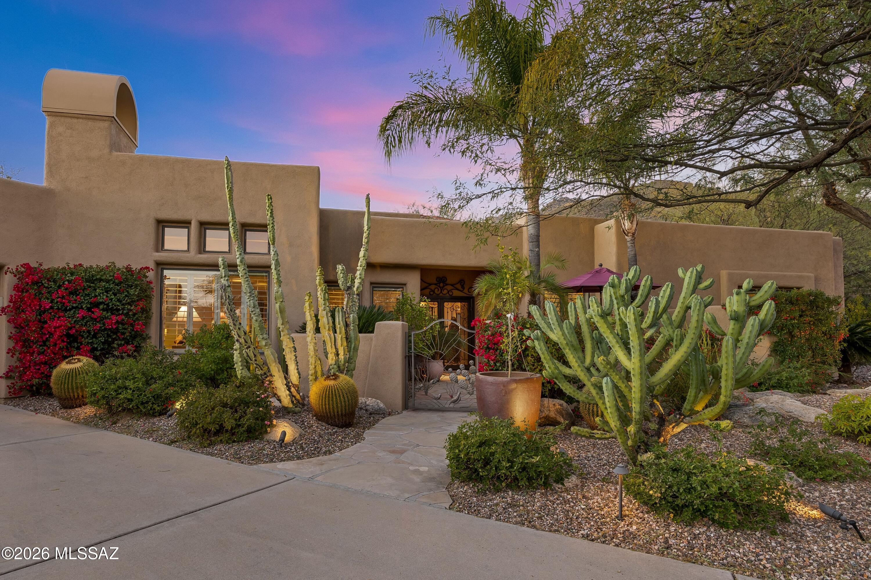 Lovely home in guard-gated Ventana Canyon Country Club has been impeccably maintained and is move-in ready. Cathedral ceilings w/wood beams, beautiful scored concrete floors & 3 fireplaces provide character & warmth. Bright open floorplan enhanced by skylights & walls of windows to bring in lots of natural light. Plantation Shutters & Motorized Hunter Douglas blinds on all the windows. Huge Primary BR w/sitting area & Beehive FP. Spacious kitchen boasts updated appliances, island w/gas cooktop, breakfast bar, pantry, tons of storage/counter space. Formal living + dining plus cozy family rm off kitchen. Inviting front courtyard & beautifully landscaped back patio with mountain views, plunge-pool (w/spa jets), multiple sitting areas, legacy cacti. Too much to list, you must see for yourself