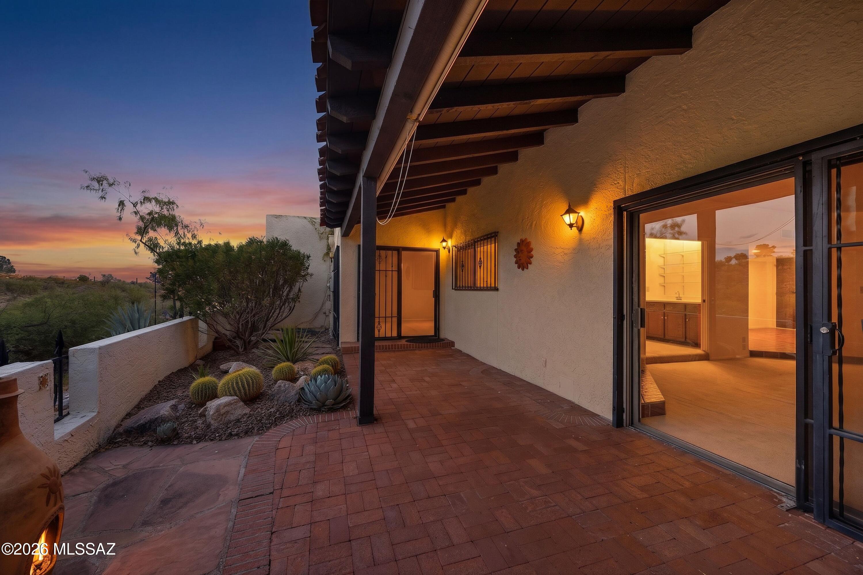 Mountain views, timeless Tucson character come together in this inviting townhome in the desirable Westward Look community. From the back patio, enjoy fabulous views of the Catalina Mtns & surrounding desert, a beautiful backdrop for morning coffee, evening sunsets. Roof recoated June 2026, Heat Pump 2-3 yrs old, water heater to be replaced. Inside, the home offers warm Southwestern charm with Saltillo tile, wood cabinetry, exposed beam details, a fireplace, & abundant natural light. The kitchen provides generous storage. Spacious bedrooms & the additional bedroom/flex space with wet bar creates an ideal home office, guest area, studio, or hobby room. Laundry room is off of the breakfast nook. The 2-car garage adds convenience. This is a rare blend of privacy, views, character, & potential